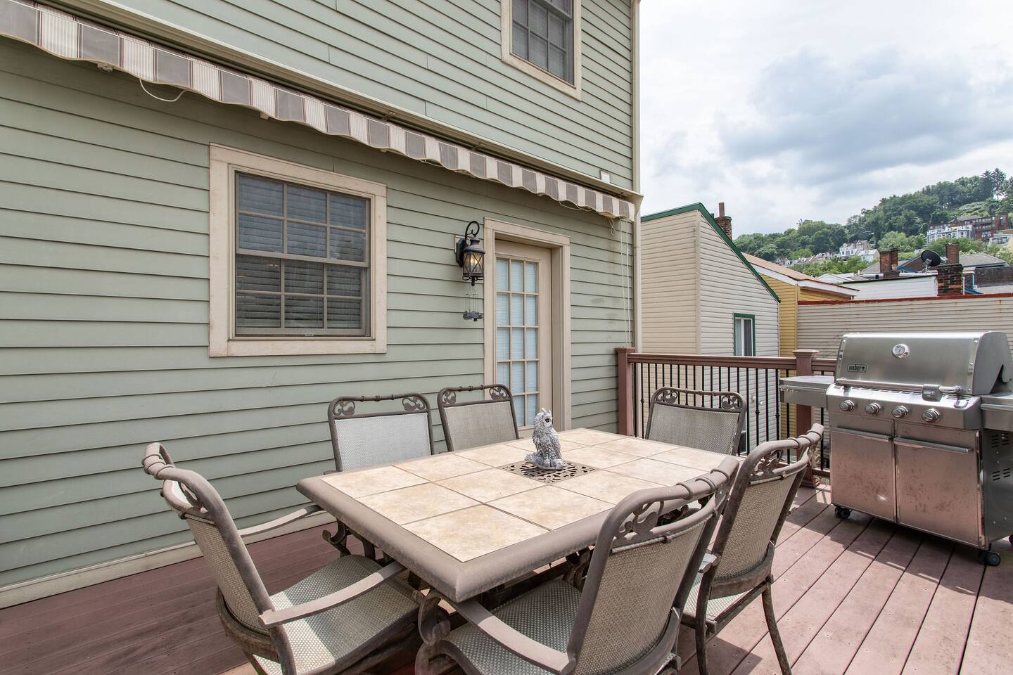 Spacious 6-seater dining area on the back porch, perfect for outdoor meals, gatherings, or enjoying a relaxed meal with a view.