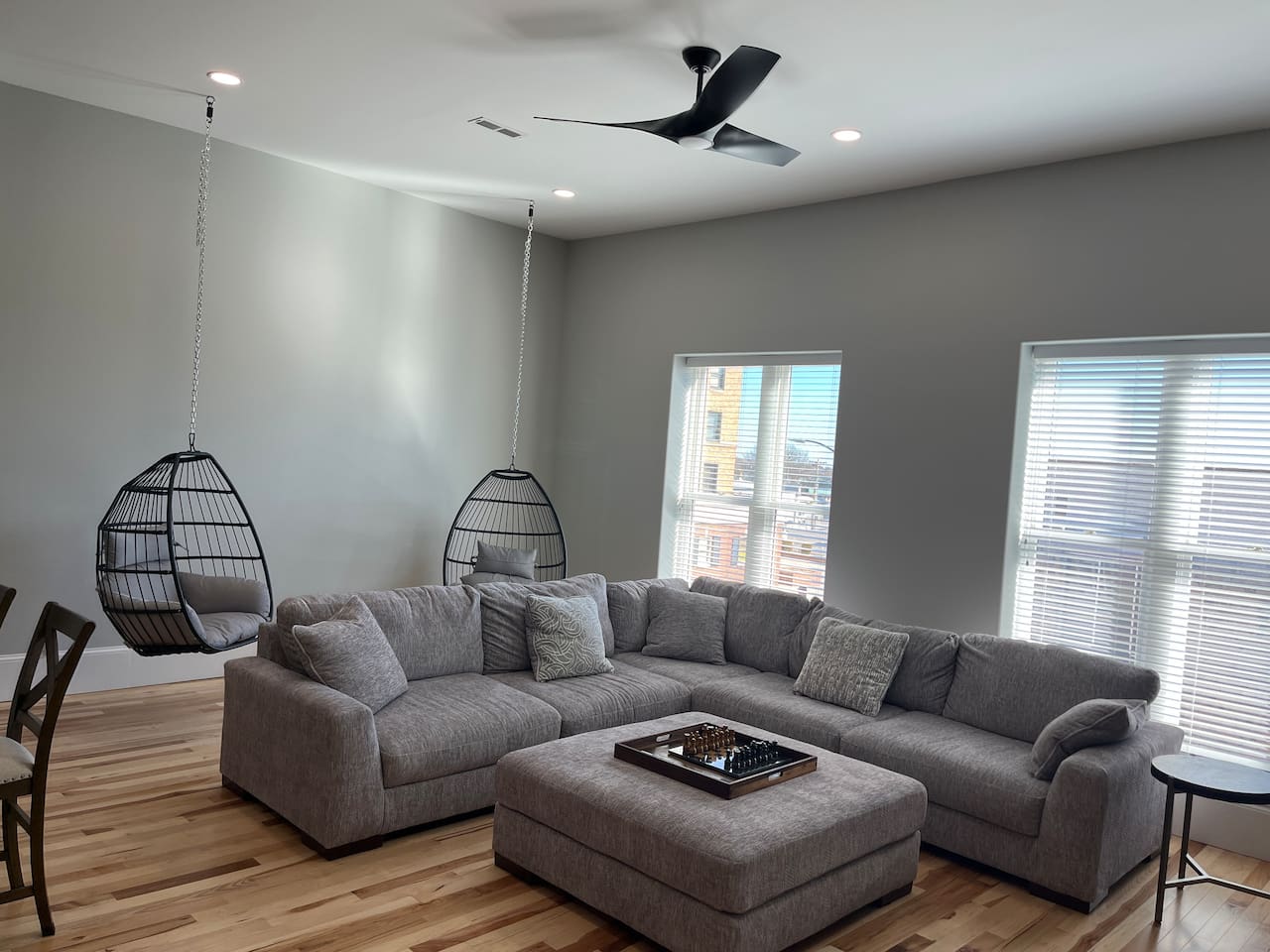 Relax in 1 of the 2 hanging chairs while enjoying the view of Main St in downtime Hays!