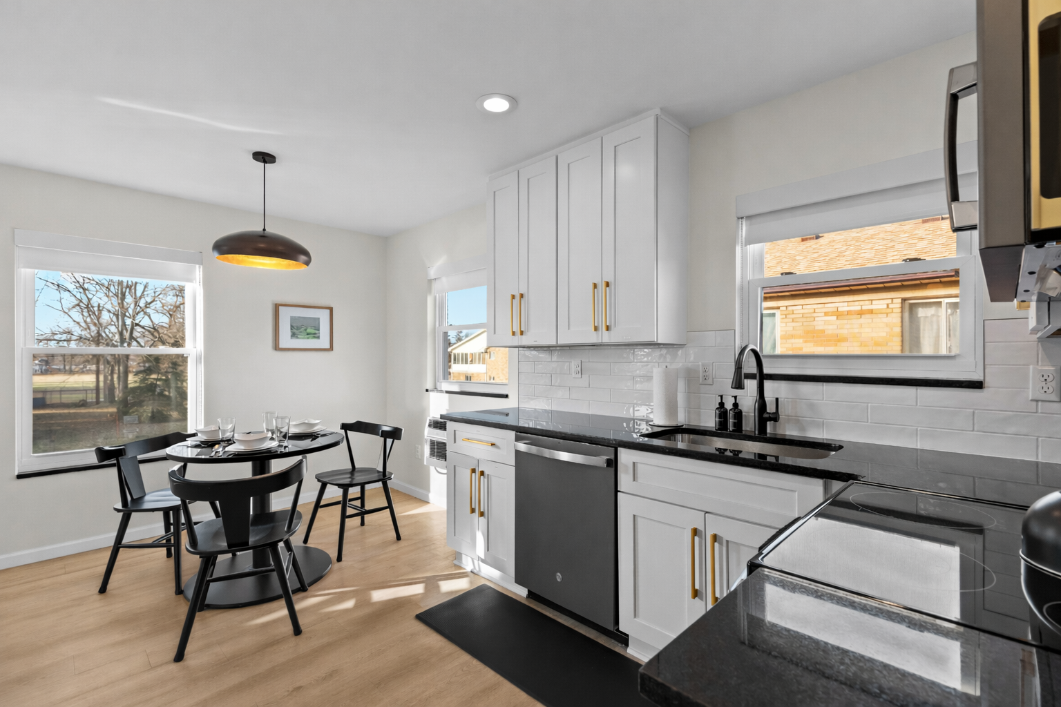 Bright, open kitchen and dining area with modern finishes, sunlit windows, and a cozy table—perfect for cooking, dining, and relaxed everyday living.