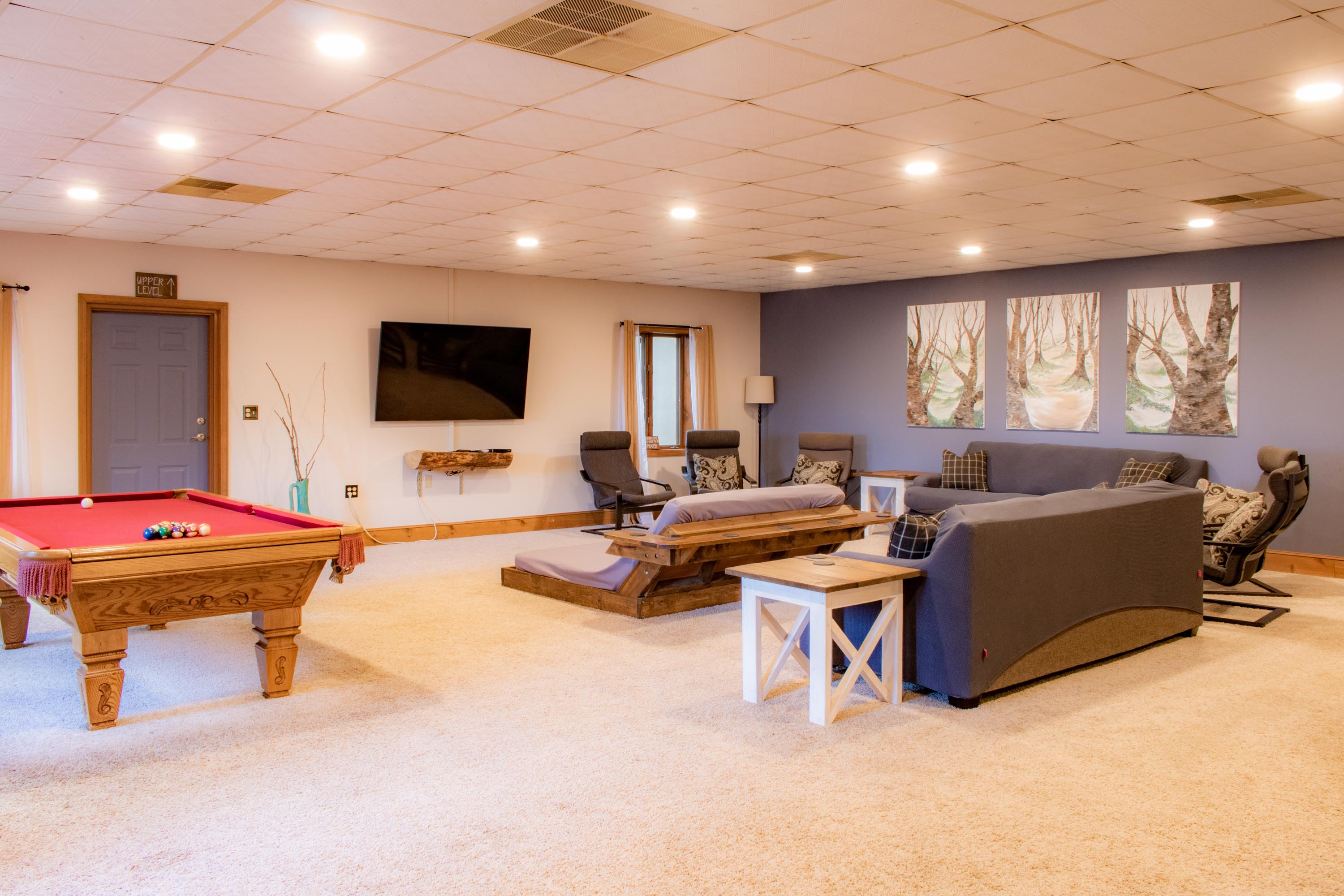 Lower level Living Room complete with comfy seating, 70" SmartTV, and a Pool Table!
