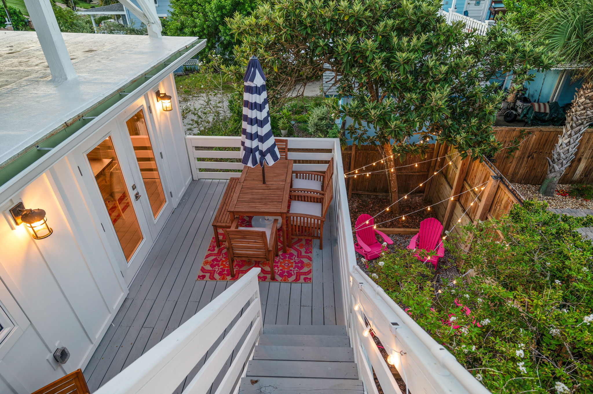 This photo gives you a great sense of the outdoor deck and backyard space. While cozy, it’s thoughtfully layered to create intimate spots for dining, chatting, or relaxing. Even with a large crowd, everyone can find their own little nook to enjoy!
