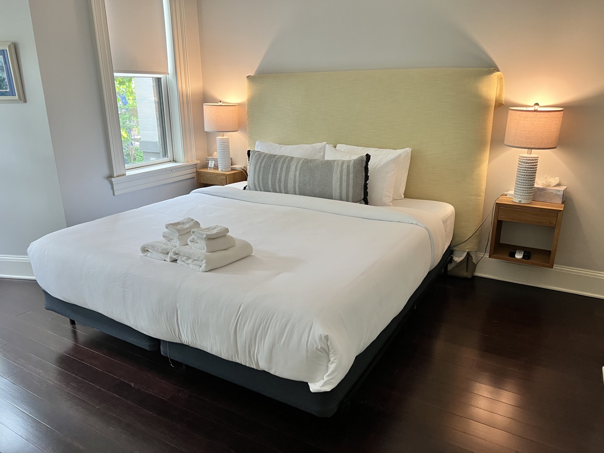Spacious main bedroom with a newly upgraded plush Serta king bed, tranquil tree-lined views, and a 40" Samsung 4K Smart TV—perfect for rest, relaxation, and streaming.