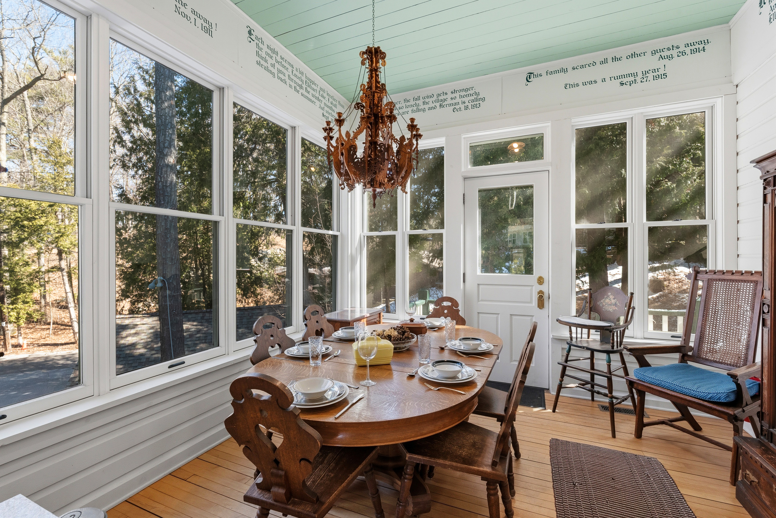Dining room w/ large windows & elegant table setting