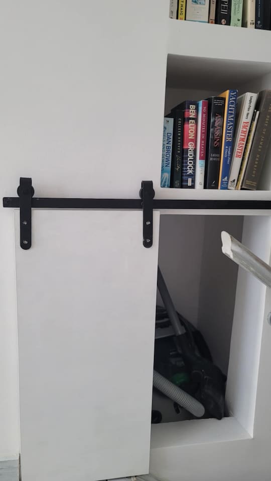 Bookshelves and a hidden compartment for the vacuum