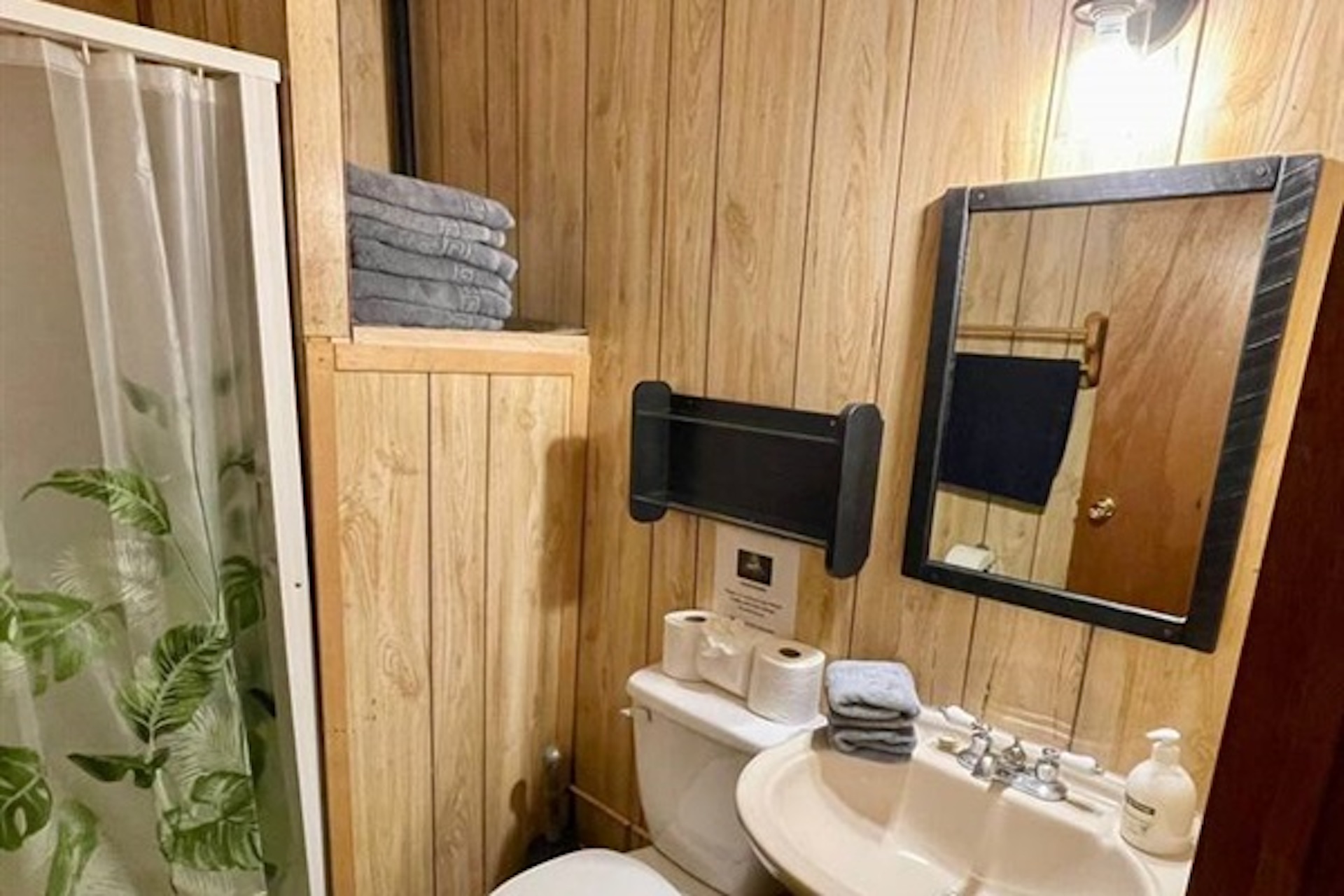 Bathroom vanity and shower with warm wood finishes