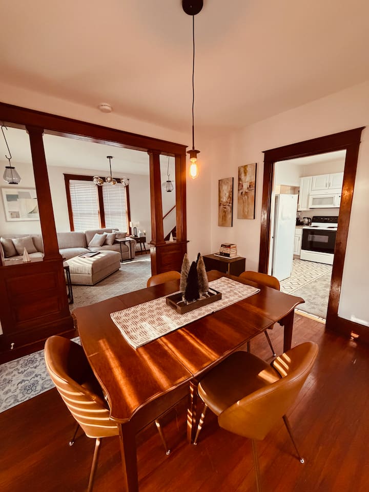 Dining area with seating for meals or game nights, open to the living room and kitchen