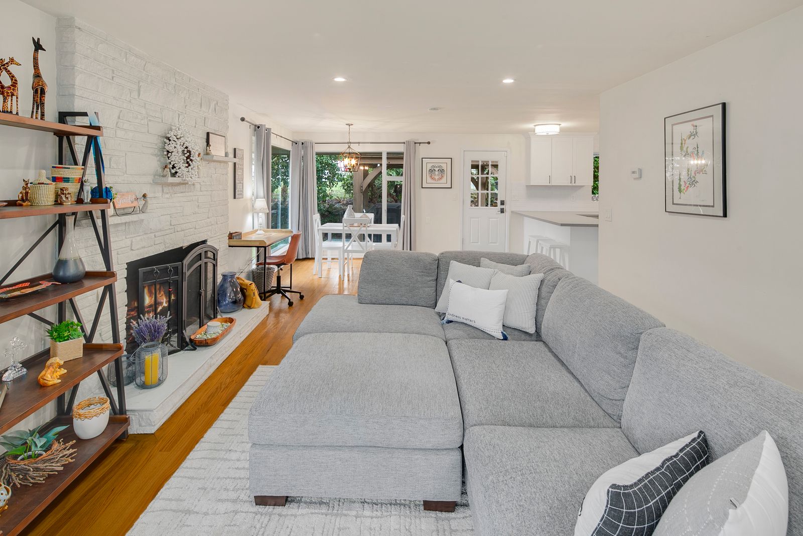Bright and inviting living/dining area with a comfy sectional, perfect for relaxing after a day of exploring