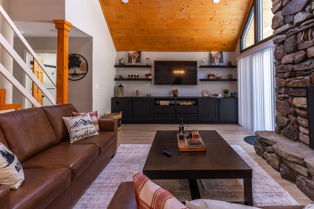 Warm, inviting living room with comfortable seating and a cozy layout. Perfect for relaxing, reconnecting, and unwinding with friends and family.