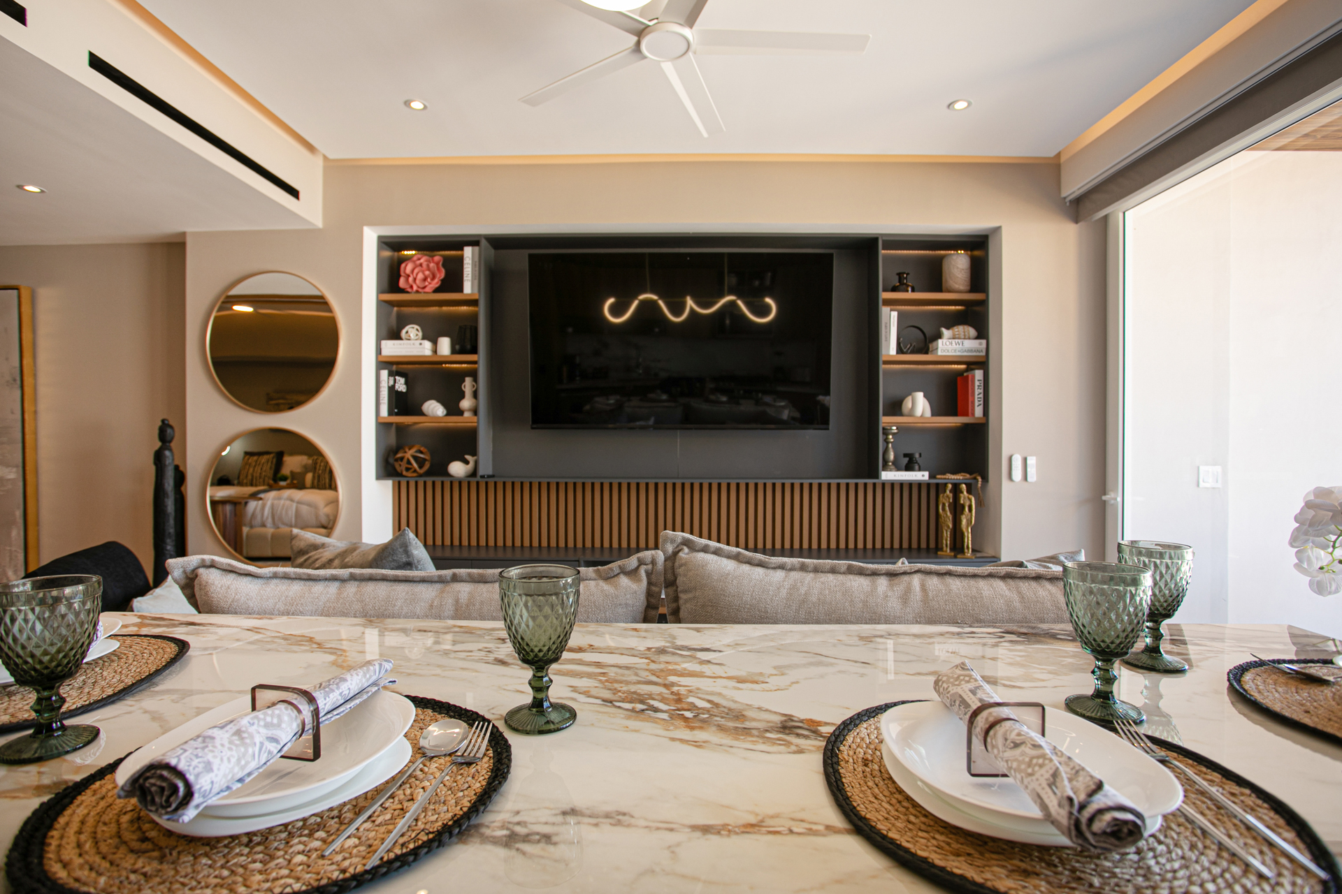 From the modern kitchen, enjoy sightlines into the chic living room with a stunning feature wall, open shelving, and a large smart TV with YouTubeTV, Amazon Prime, and more