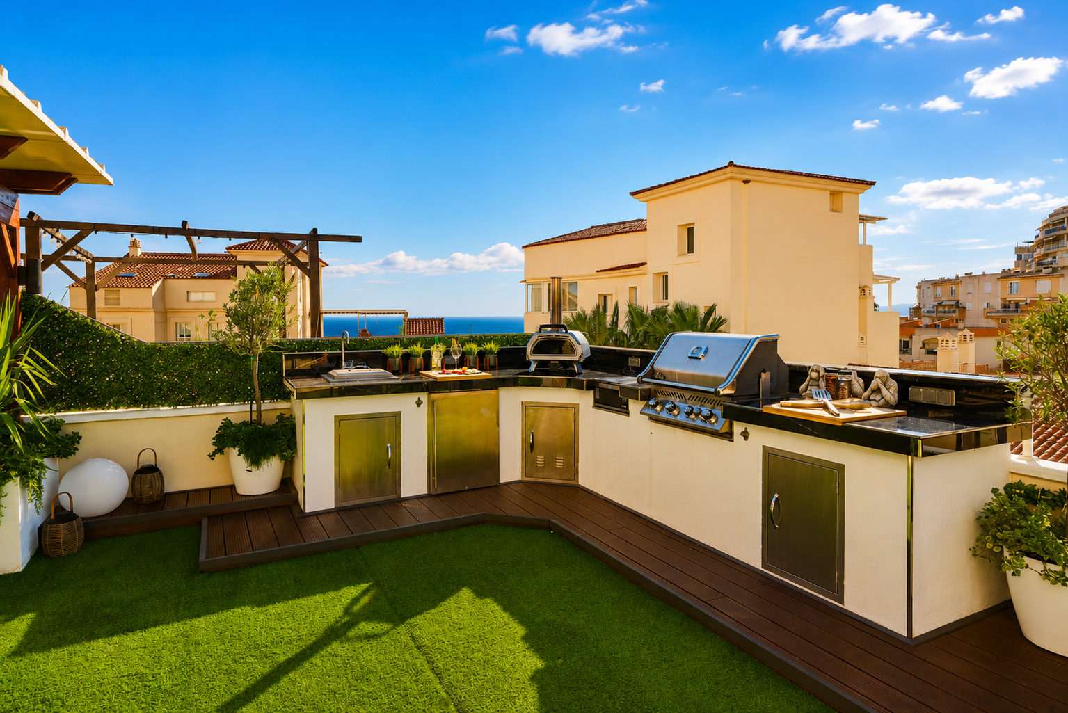 Cook with a view in the fully equipped outdoor kitchen featuring a BBQ, pizza oven, fridge, and sink. Dine al fresco under the open sky surrounded by soft lighting and fresh sea breeze.