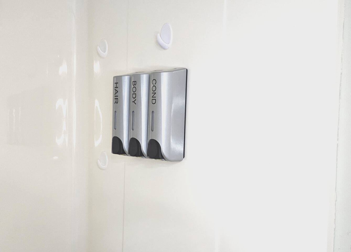 Shampoo, conditioner, and body wash dispensers are provided in each bathroom. 