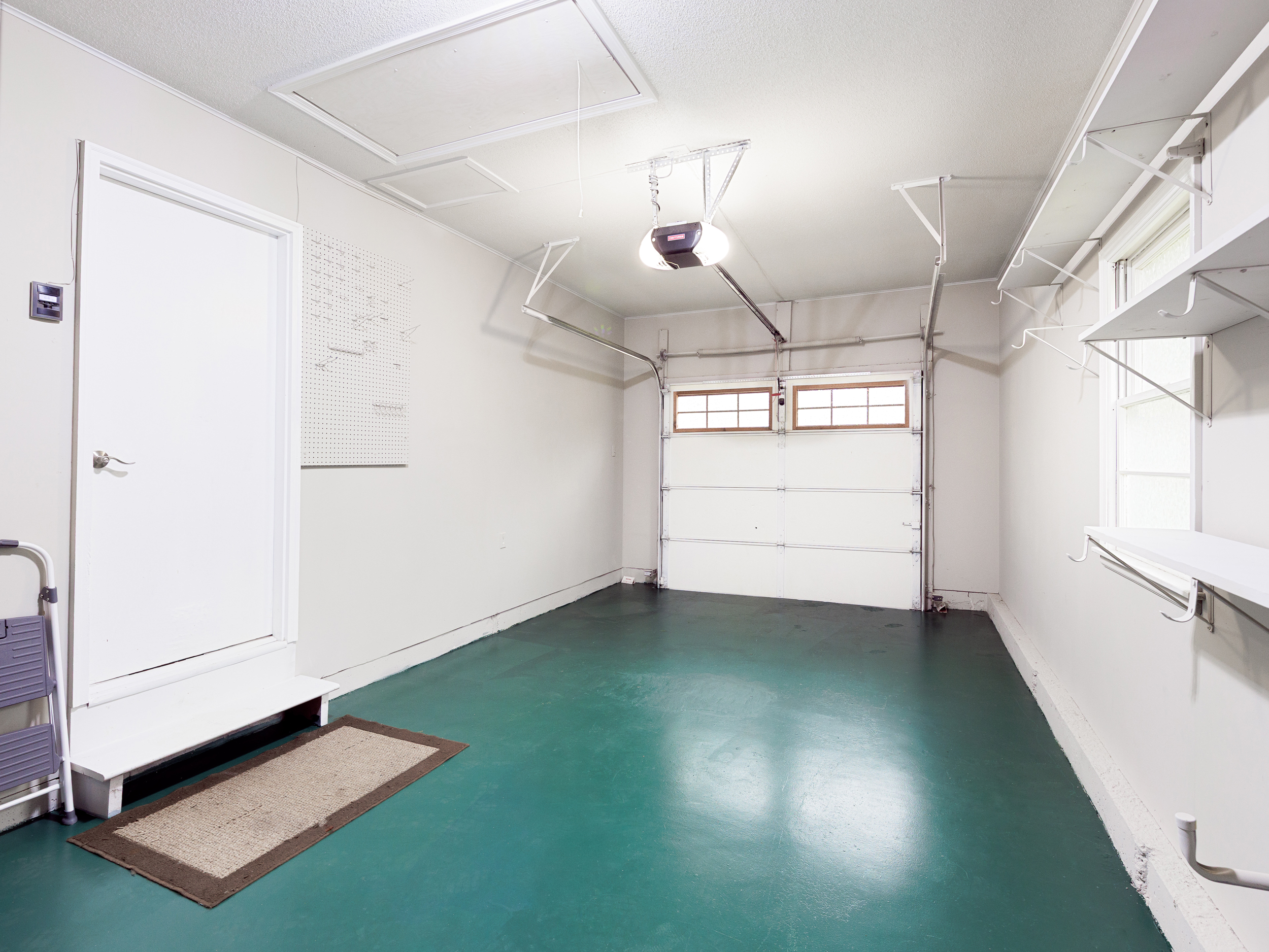 Attached garage with interior access and additional storage space.