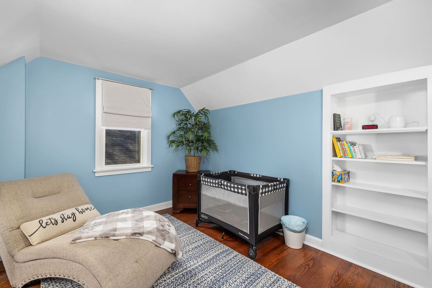 Upstairs bedroom 4 has cozy space for baby including Pack-n-Play with bassinet, board books for bedtime stories, and lounge area for mom or dad during naptime.  There is a retractable baby gate at top of stairs in the hall.