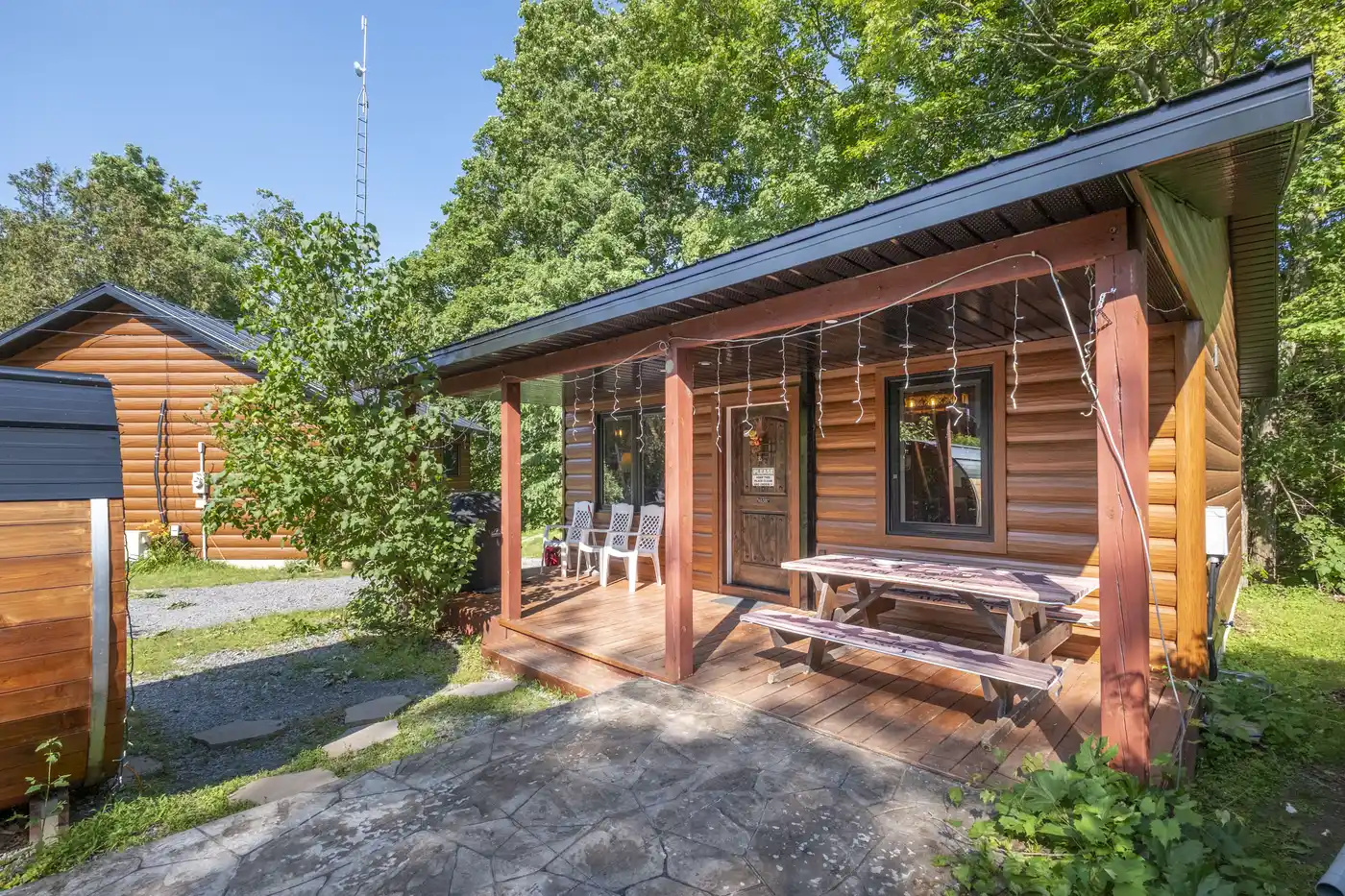 Front view of Cottage #5 with covered porch and rustic exterior