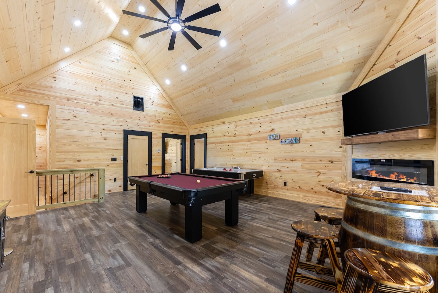 This mountain-modern game room features vaulted ceilings, rustic wood finishes, and all your favorite games—perfect for laughter-filled nights.
