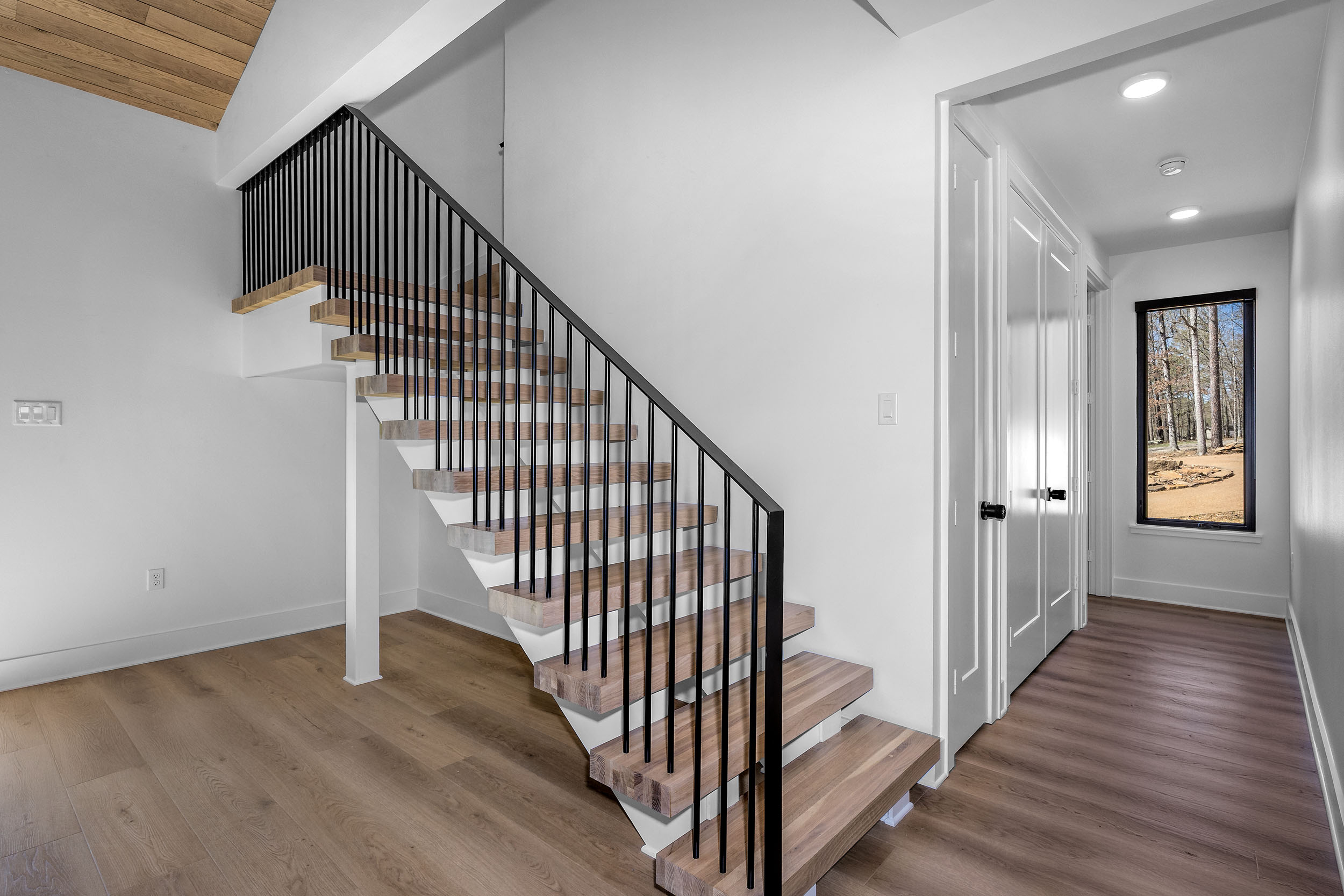 The open staircase adds architectural charm and connects the home’s spacious upper and lower floors.
