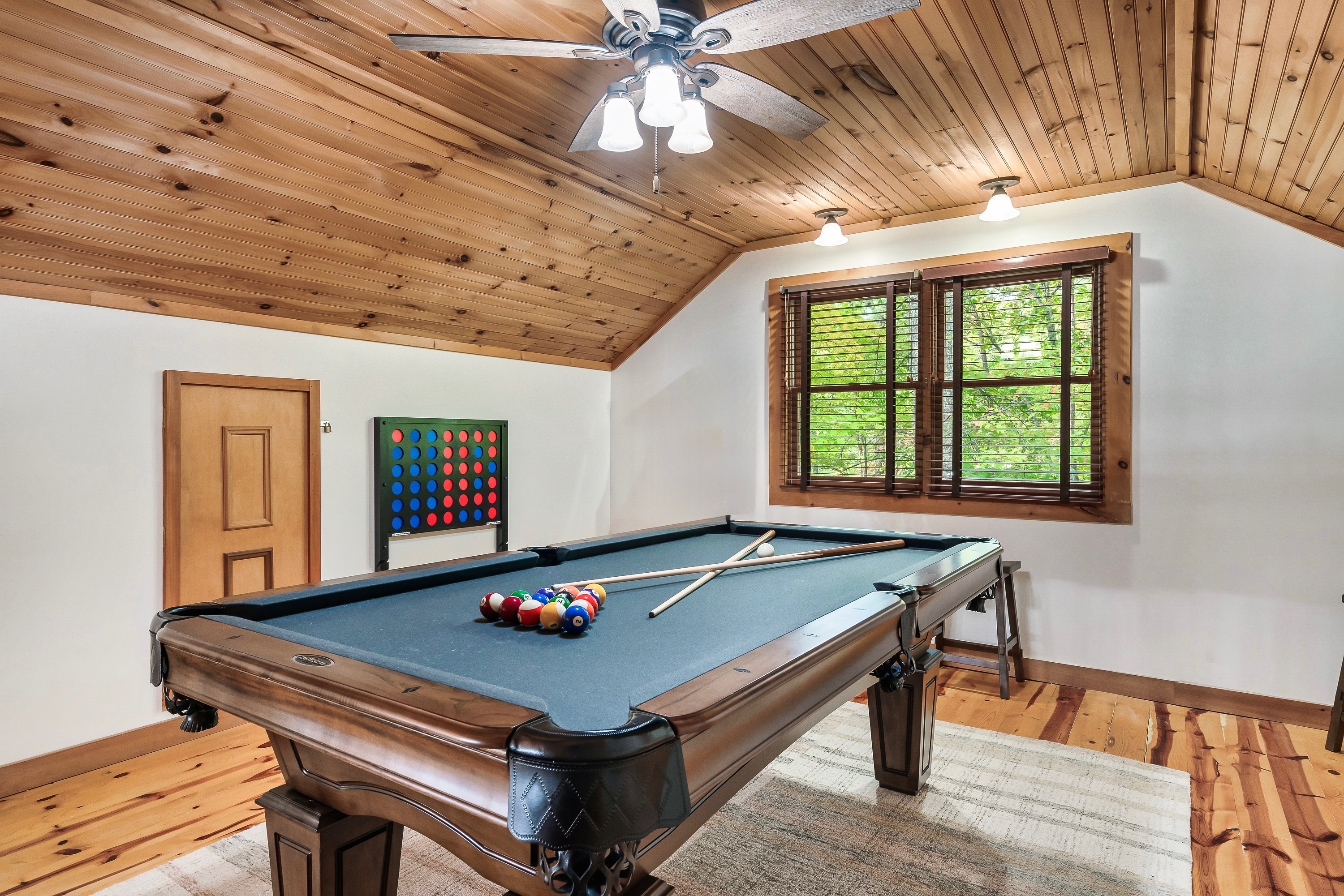 Level up your mountain getaway! 🎱✨ Enjoy friendly competition on with a game of pool. This room also has a TV (not pictured).