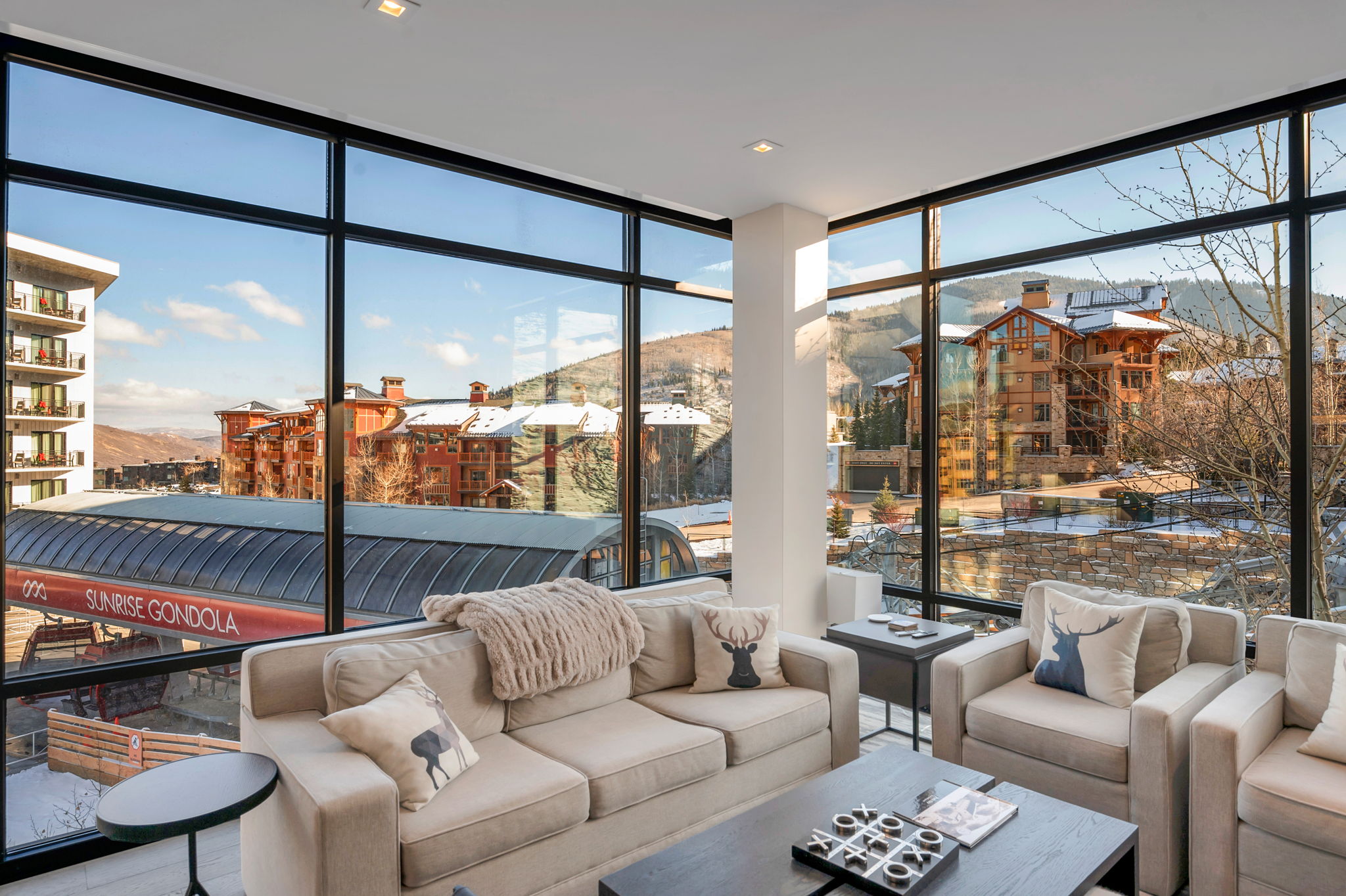 corner unit with floor to ceiling windows overlooking the new Sunrise Gondola and ski run and mountains