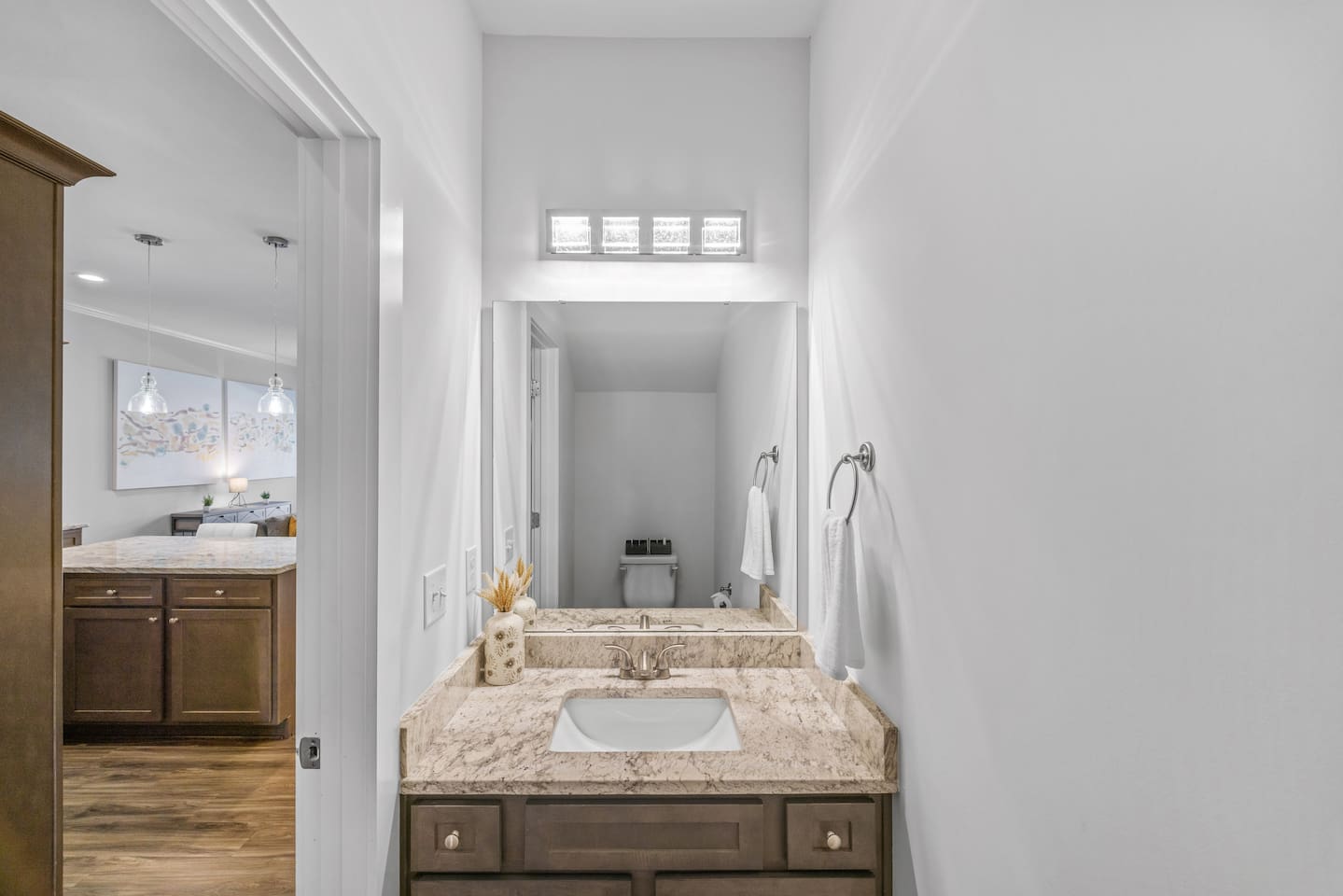 Modern vanity with granite countertop, perfect for guests and quick refreshes during your stay.