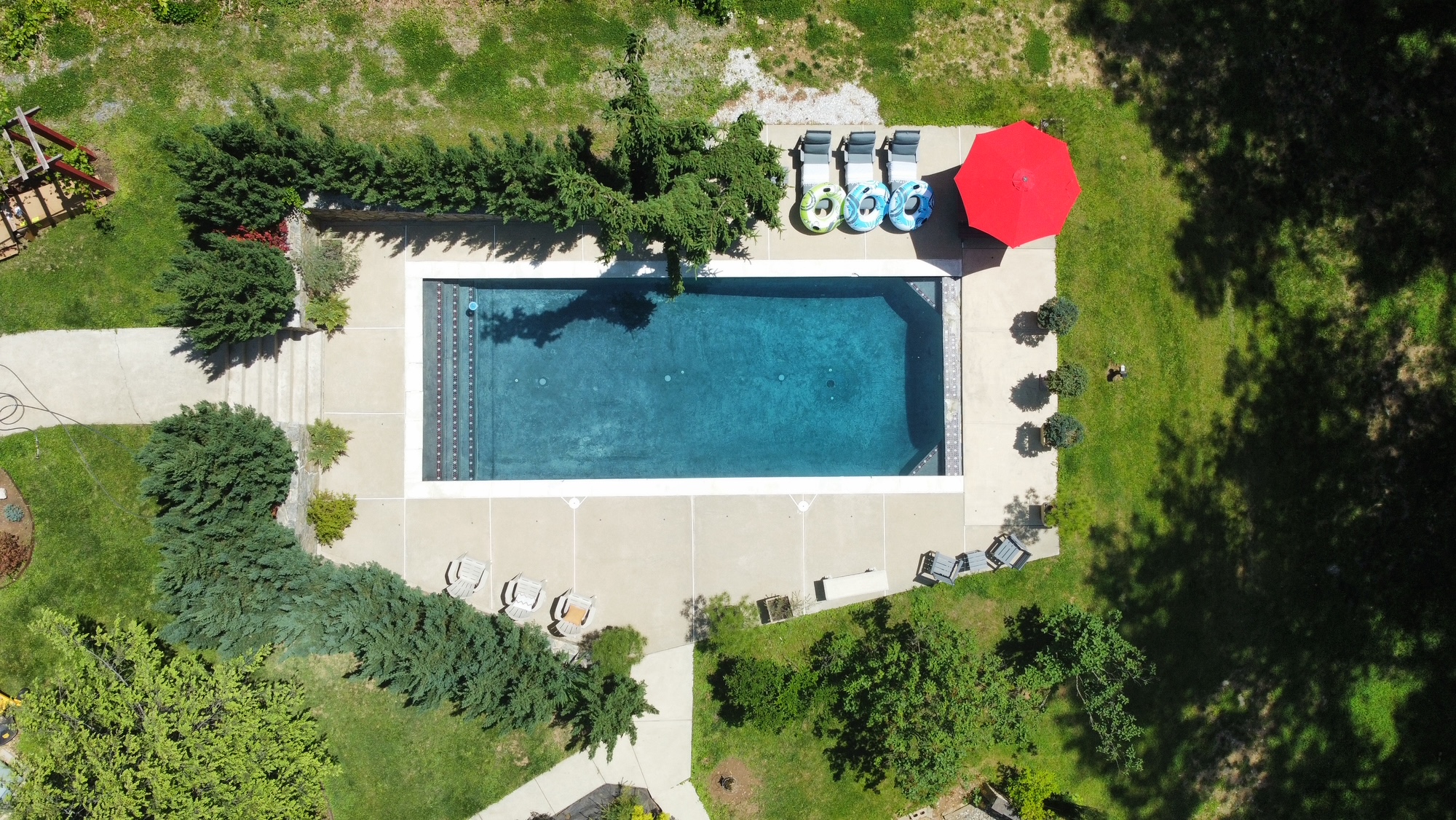 Aerial view of private pool in forest setting