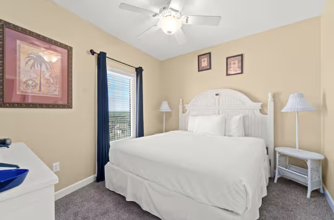 Bedroom with king bed, ceiling fan, smart TV