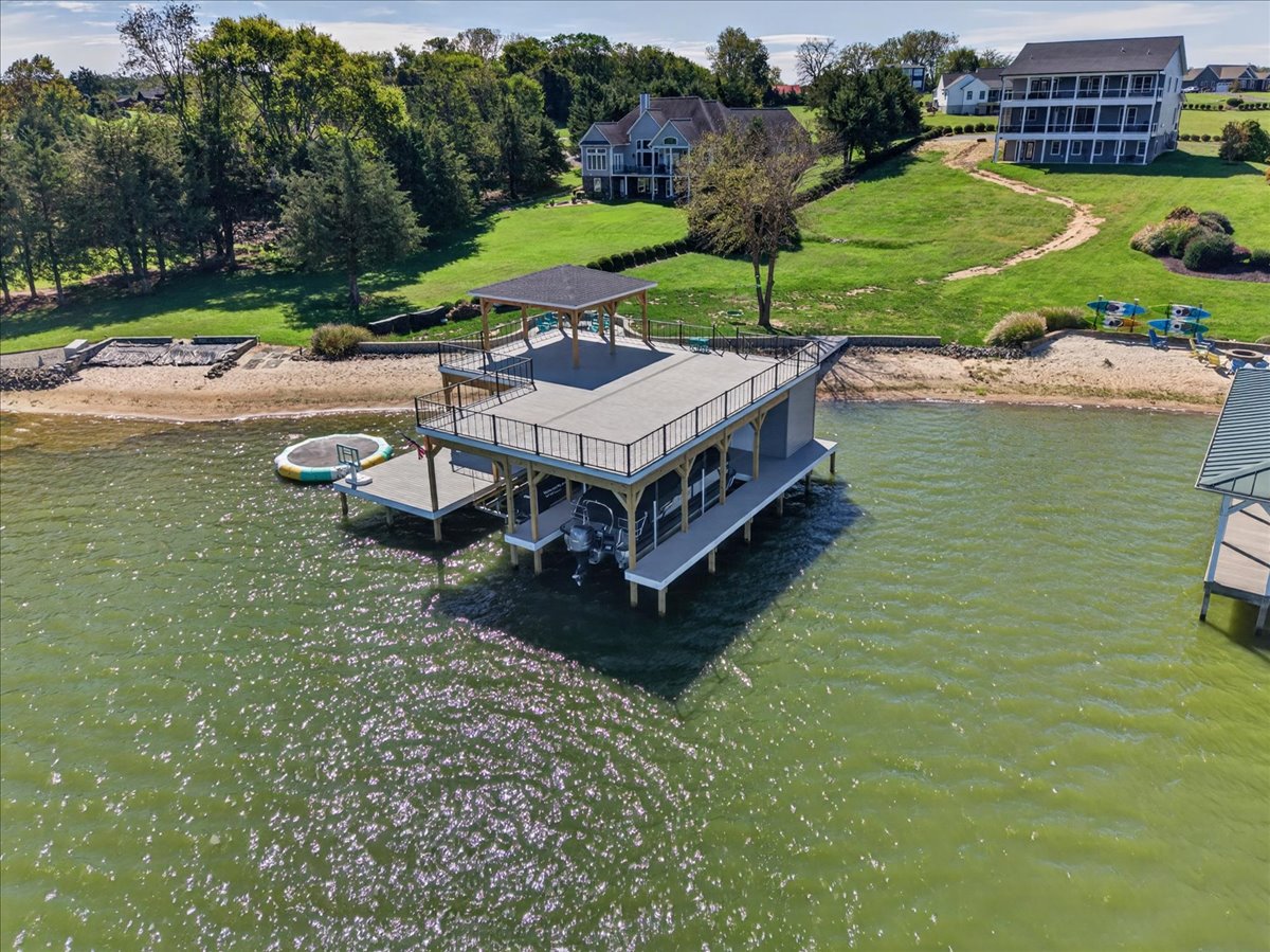 Sweeping aerial view showcasing the expansive waterfront, sandy shoreline, and beautiful Lake Anna surroundings.