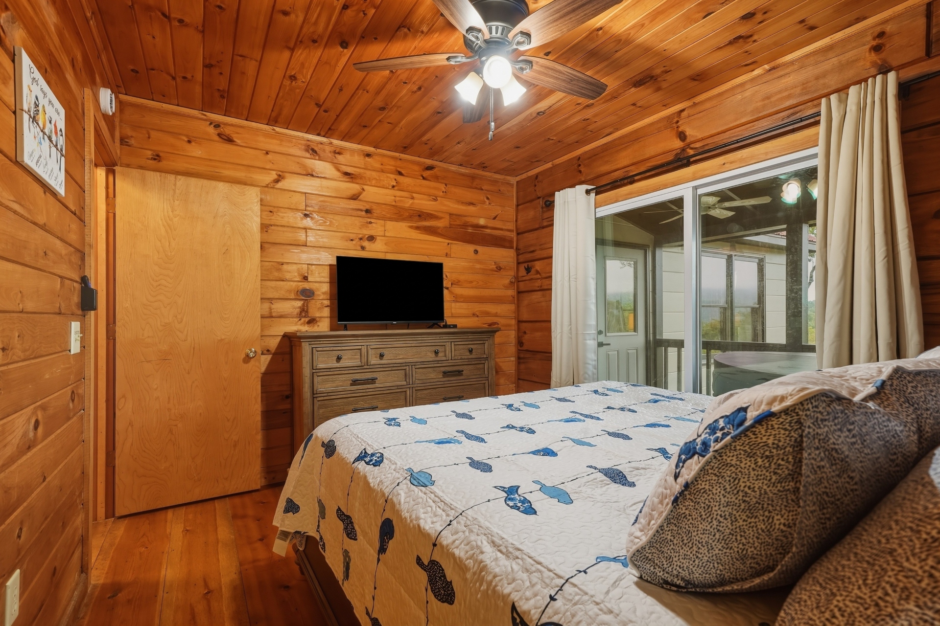 King bed with ceiling fan and smart TV