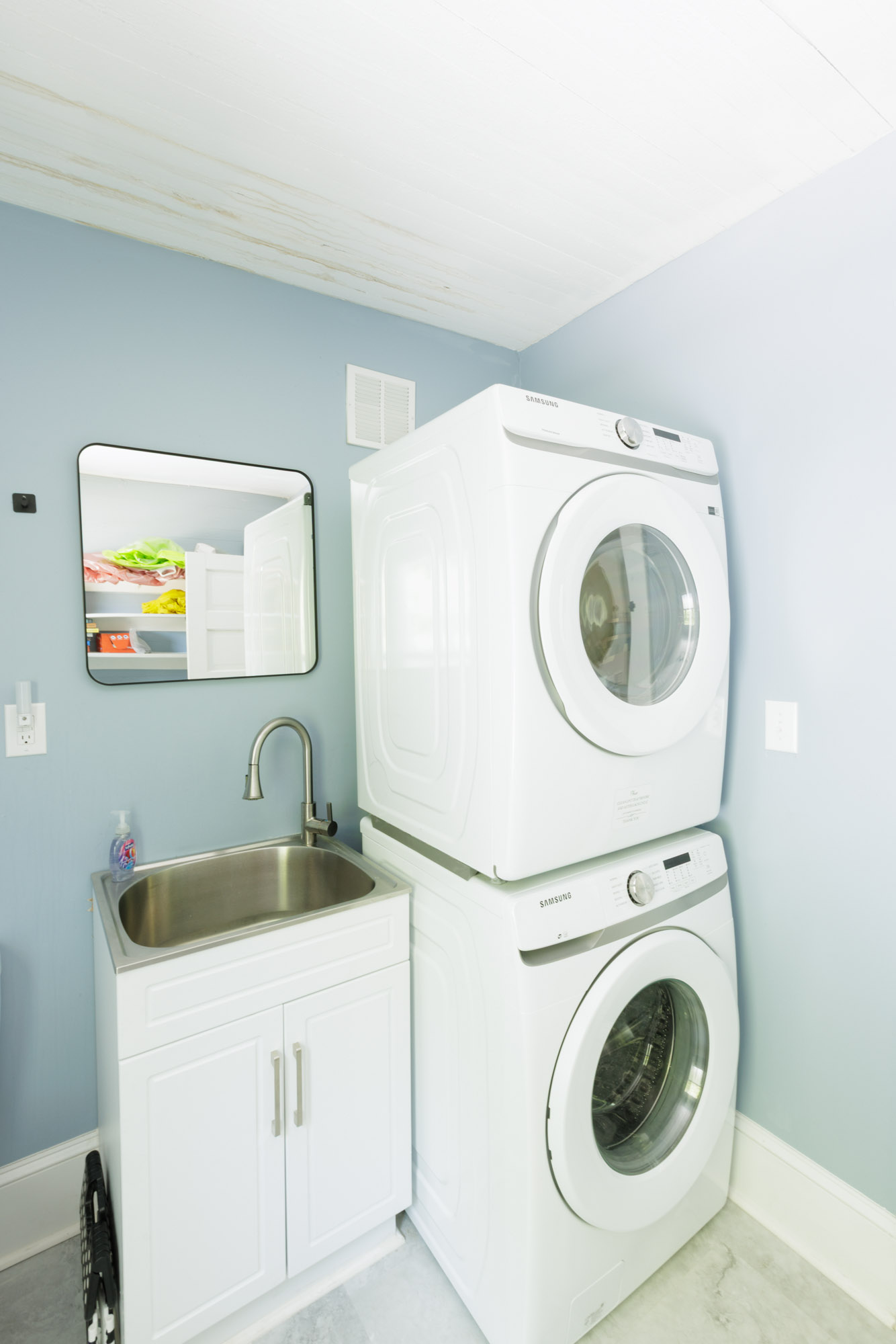 Laundry has a washer, dryer, and doubles as a half-bathroom with a toilet and sink.