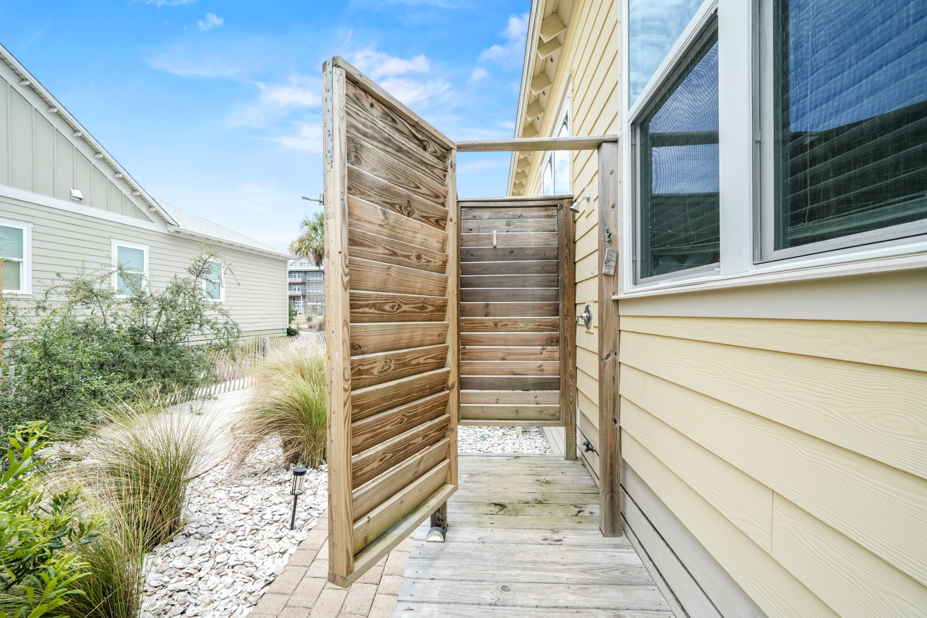 Convenient outdoor shower makes it easy to wash away the sand before heading inside
