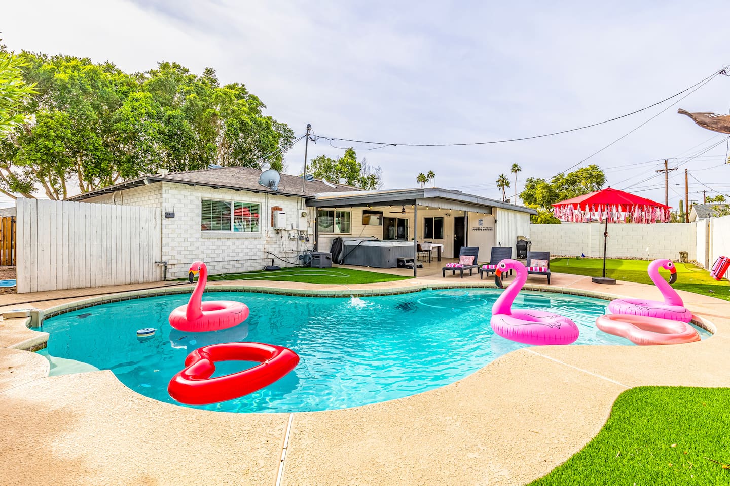 Float your cares away in this playful Scottsdale pool complete with flamingos, heart rings, and endless sunshine.

