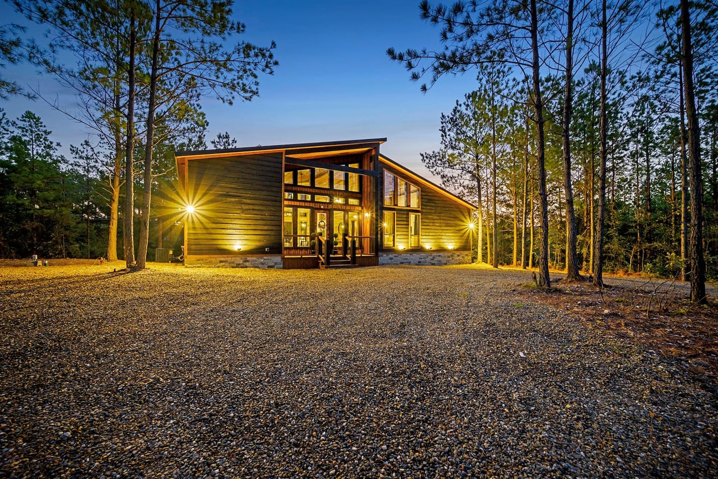 As the sun sets, the deck glows under string lights, the fire crackles, and laughter fills the night air.