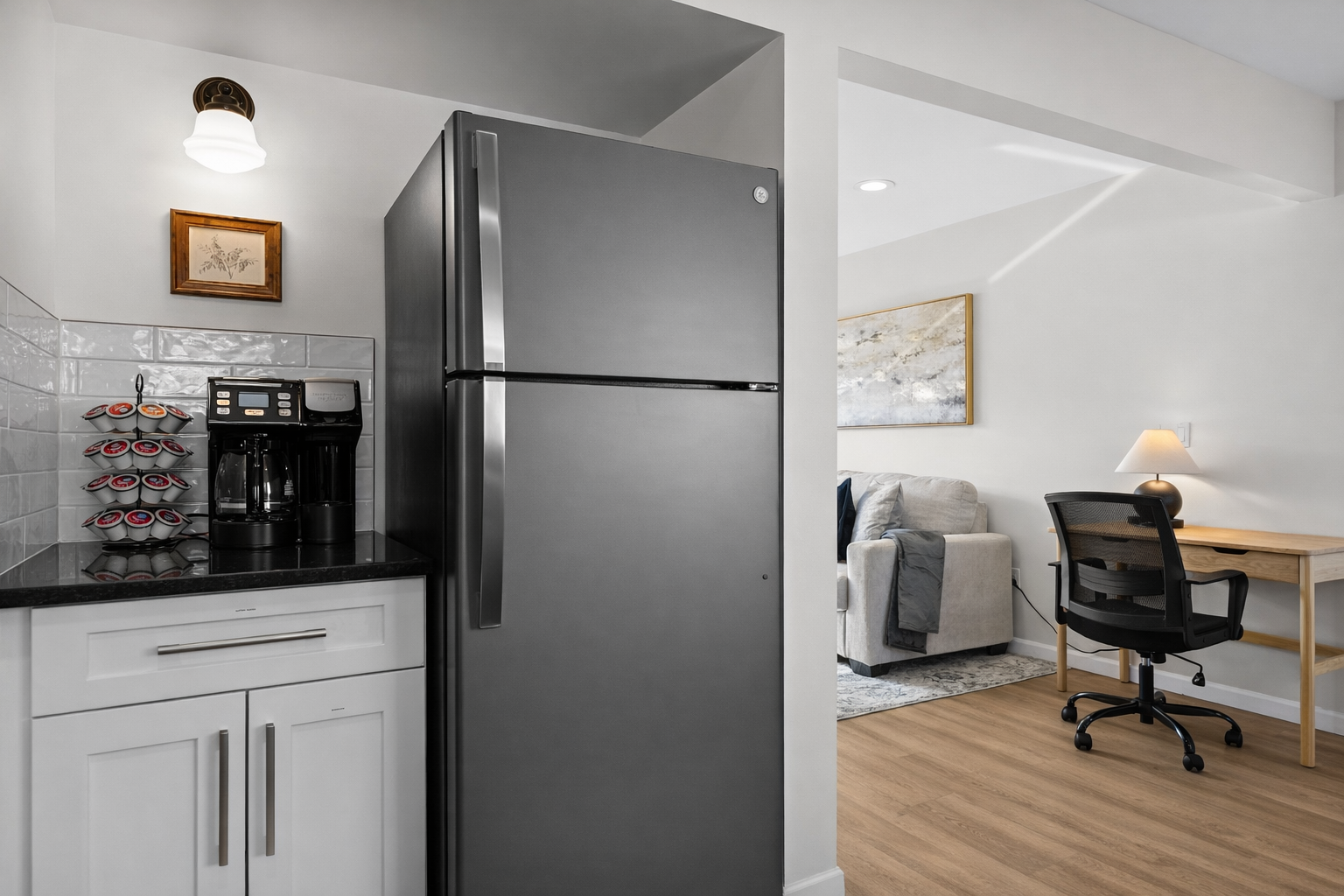 Thoughtfully designed open layout with a modern kitchen, cozy living area, and dedicated workspace—blending comfort and functionality for a seamless stay