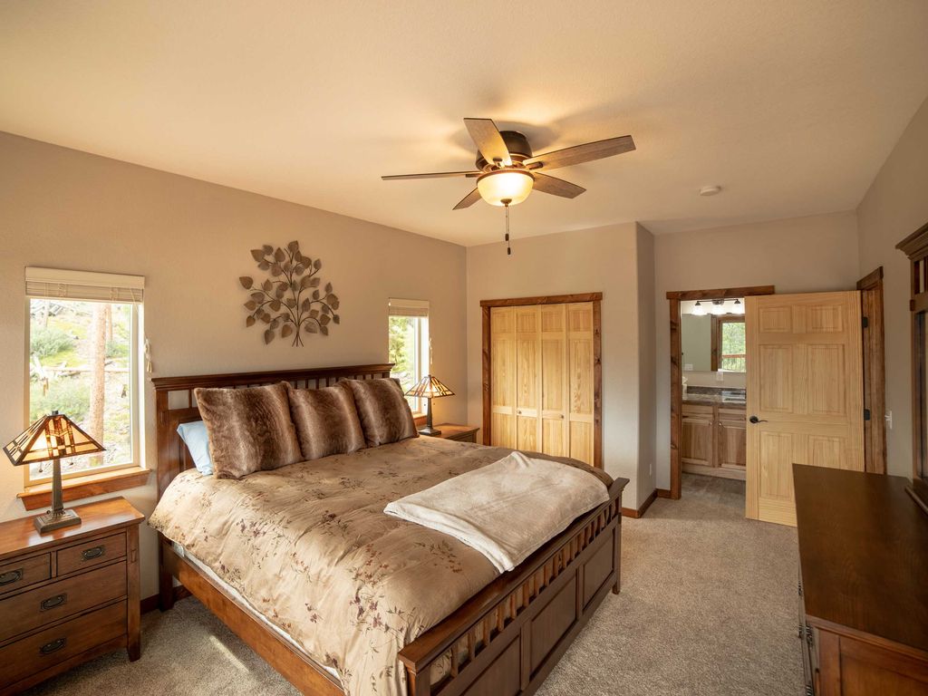 Relax in the main level bedroom featuring a comfortable king bed, stylish furniture, and a Roku Smart TV.