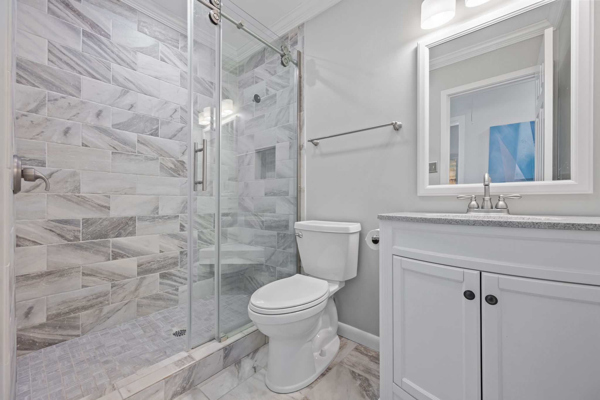The spacious walk-in shower in this full hall bathroom makes getting ready easy