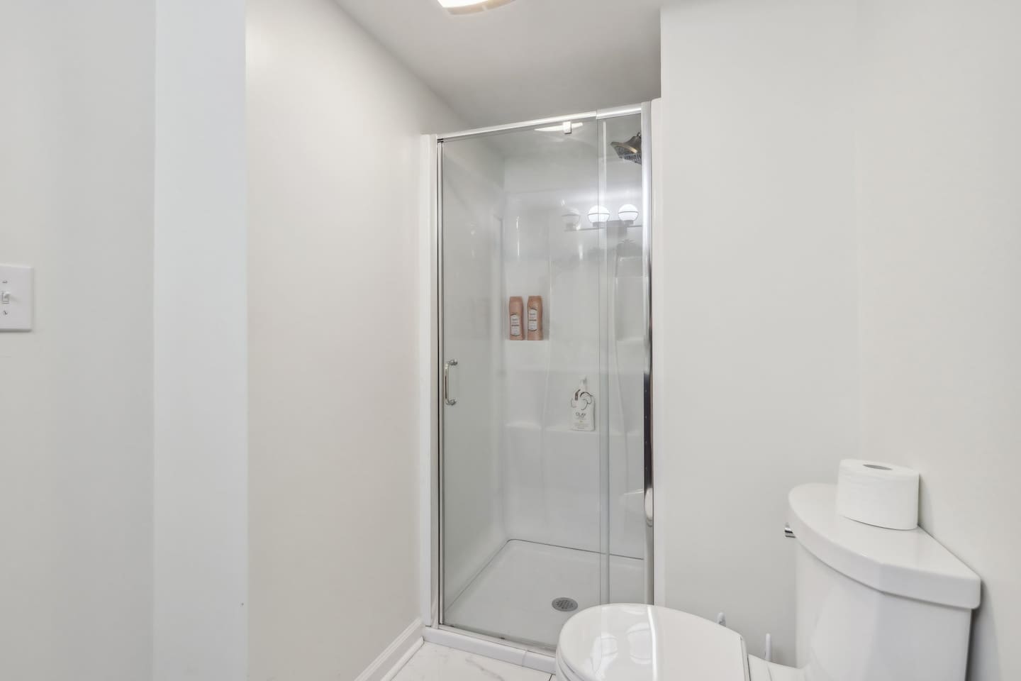 Freshen up in full bathroom 3 with a glass-enclosed walk-in shower and a bright, clean layout.
