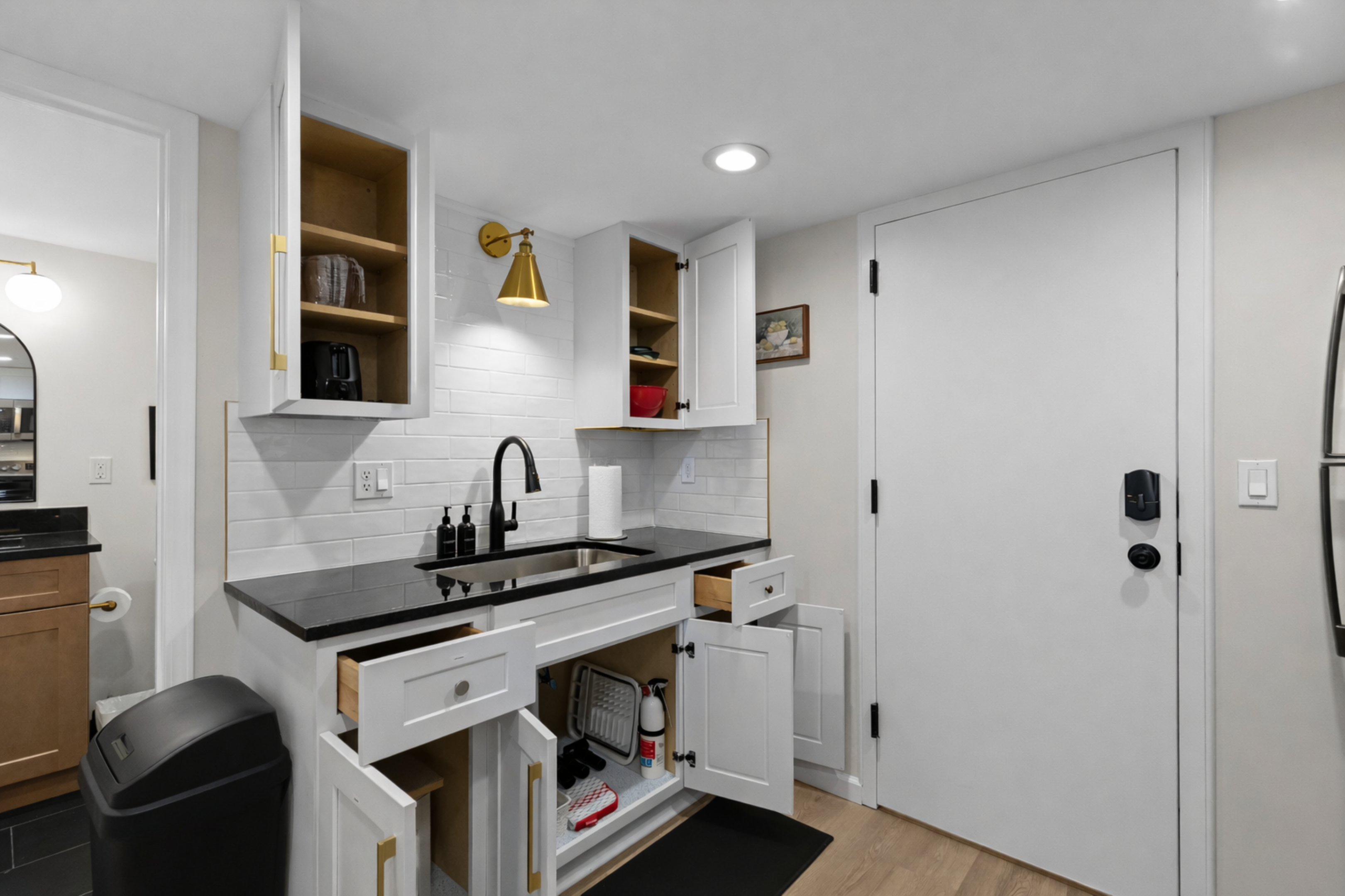 Bright, modern kitchen with sleek countertops, open shelving, quality appliances, and thoughtful storage—fully equipped for everyday cooking.