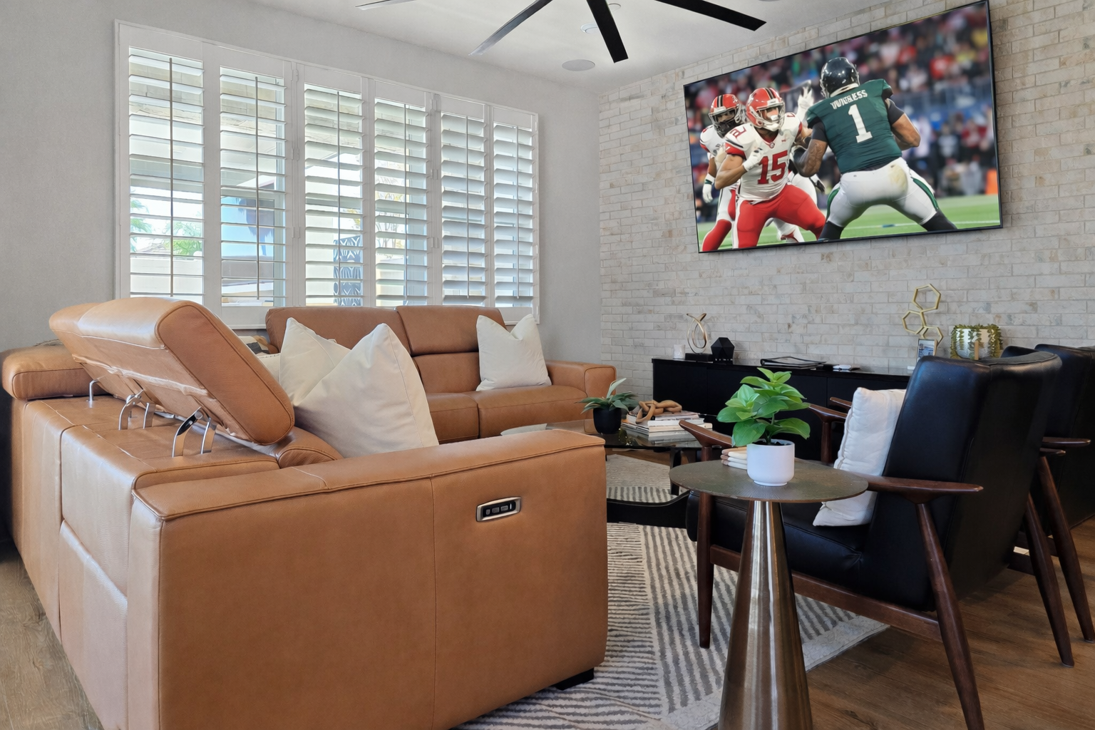 Plush Italian leather sofa & armchairs in the living room with an 87" HDTV.