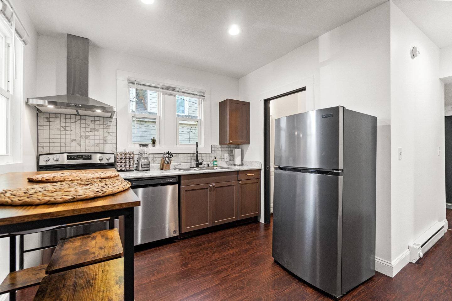 Spacious kitchen with stainless steel appliances, sleek countertops, and ample cabinet space. Perfect for cooking and gathering in a modern, inviting atmosphere!