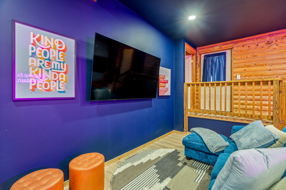 Game lounge with comfy seating and a big TV perfect for movie nights, downtime between games, or just relaxing with the group.