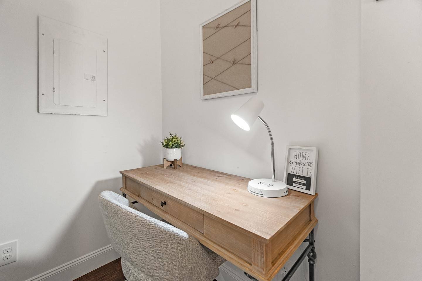 Functional workspace with a well-lit desk, a comfortable chair, and tasteful decor to inspire productivity and focus.