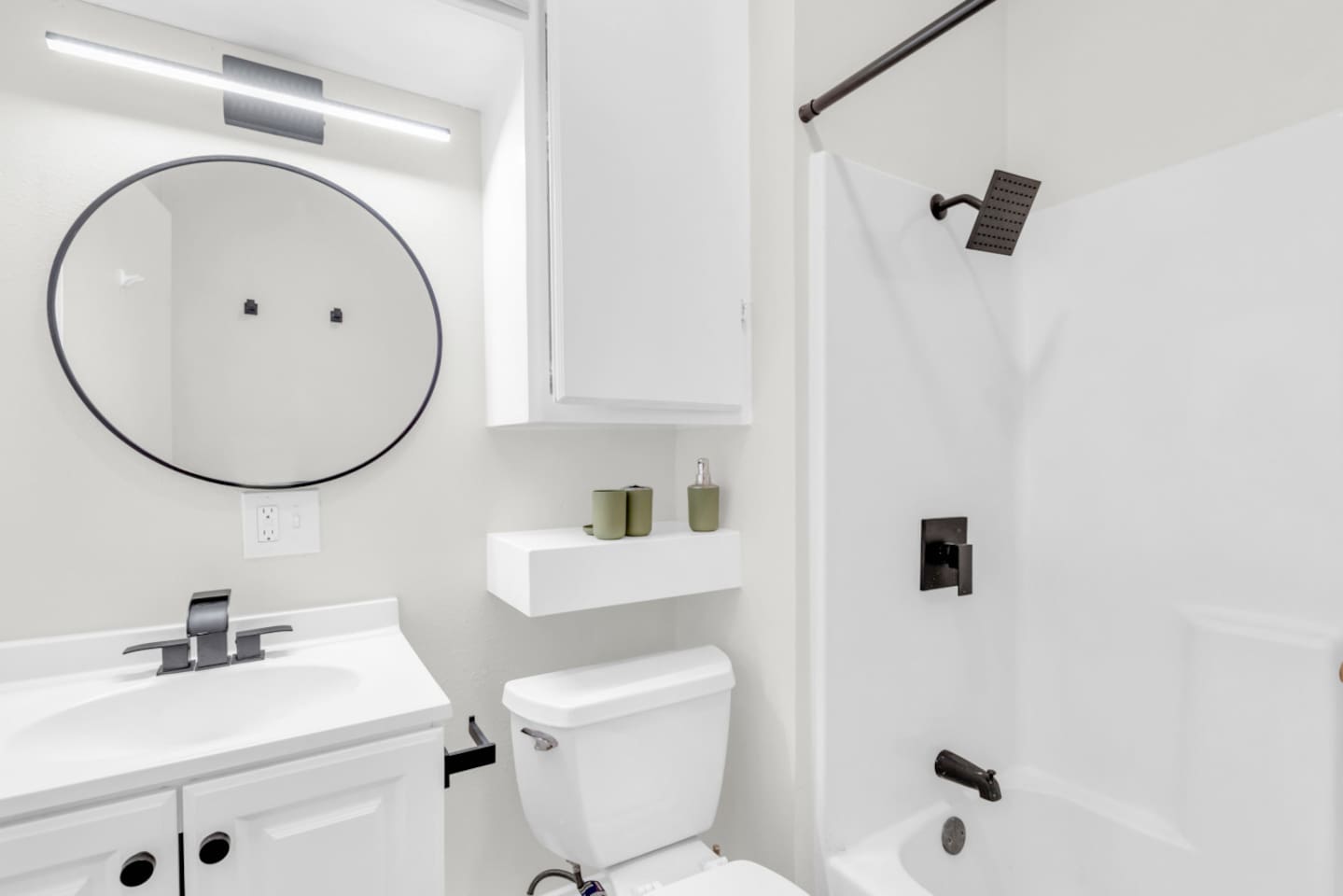 Bathroom with shower/tub combo and hotel-style touches.