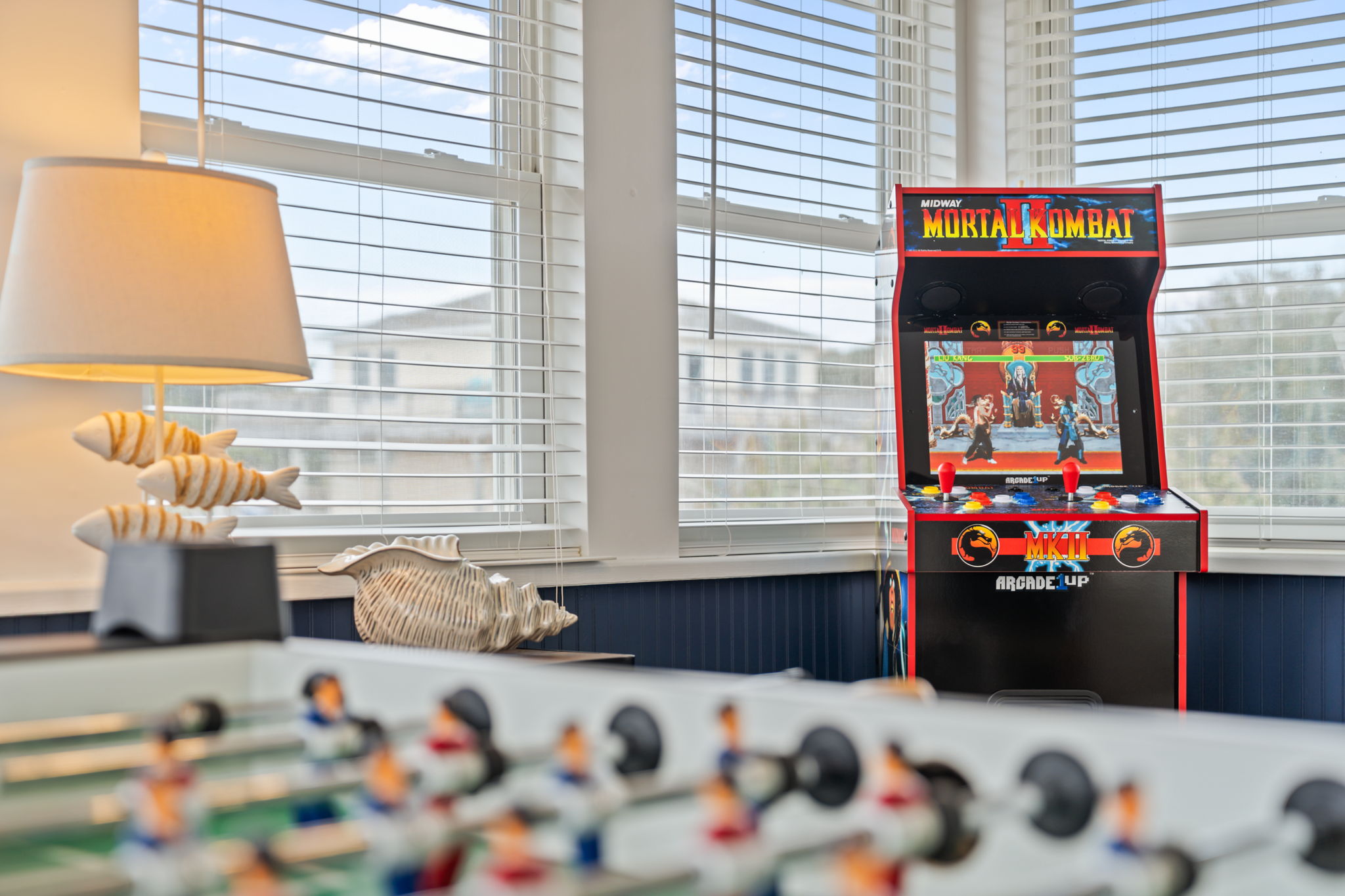 Game area with a foosball table and arcade machine for some indoor fun.