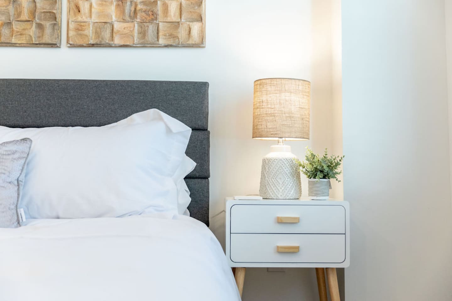 Side view of the king-size bed with a lamp and a small bedside table, adding a touch of comfort and style.