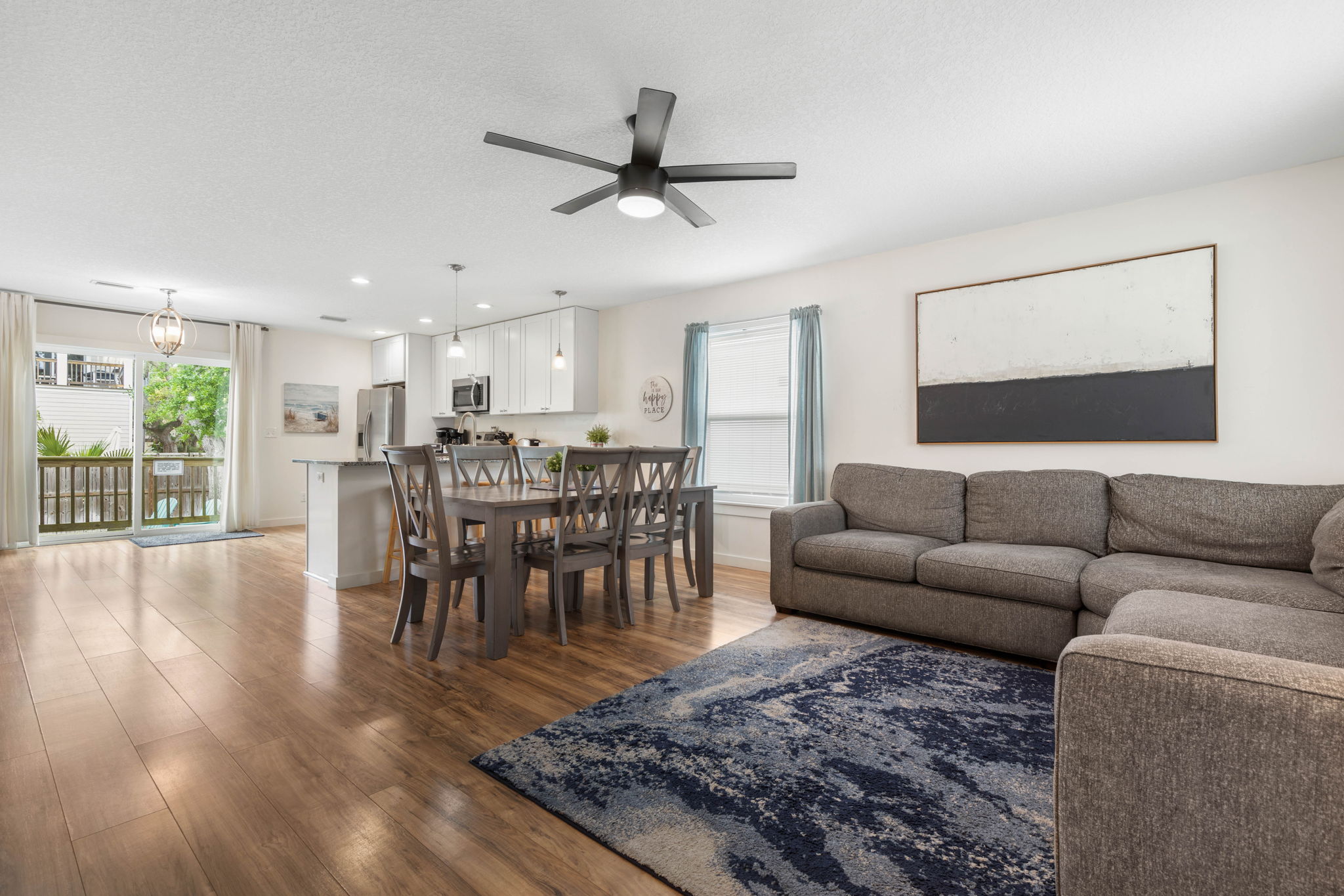 Come home from the beach, drop your flip-flops by the door, and gather here for dinner, movies, and slow evening conversation—this bright, open great room keeps everyone connected from morning coffee to the last goodnight.
