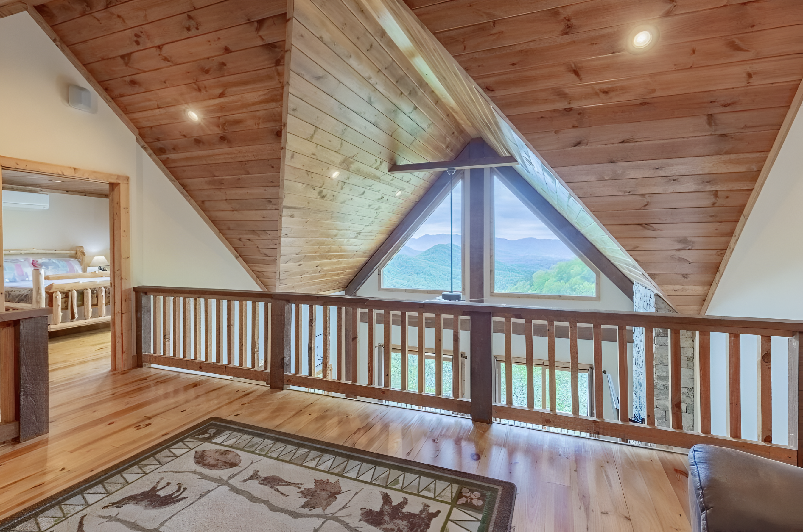 The large loft area has a bunk bed and receives lots of natural light, overlooking the living room with a great view.