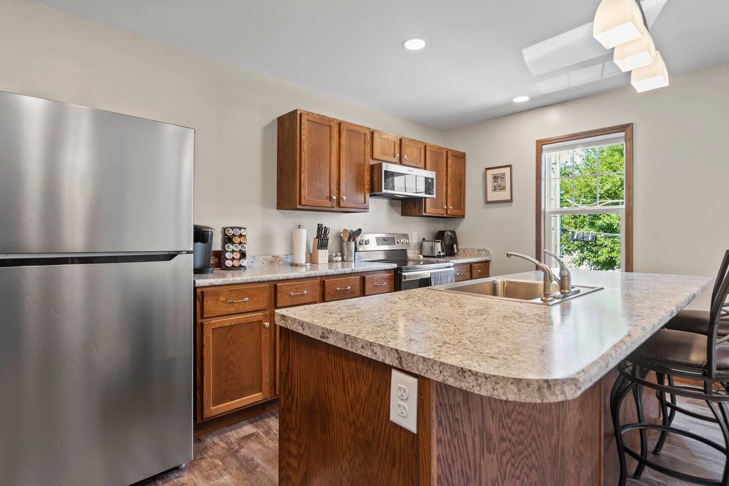 Full kitchen view showcasing modern appliances, a spacious countertop, and plenty of storage, perfect for cooking and entertaining.