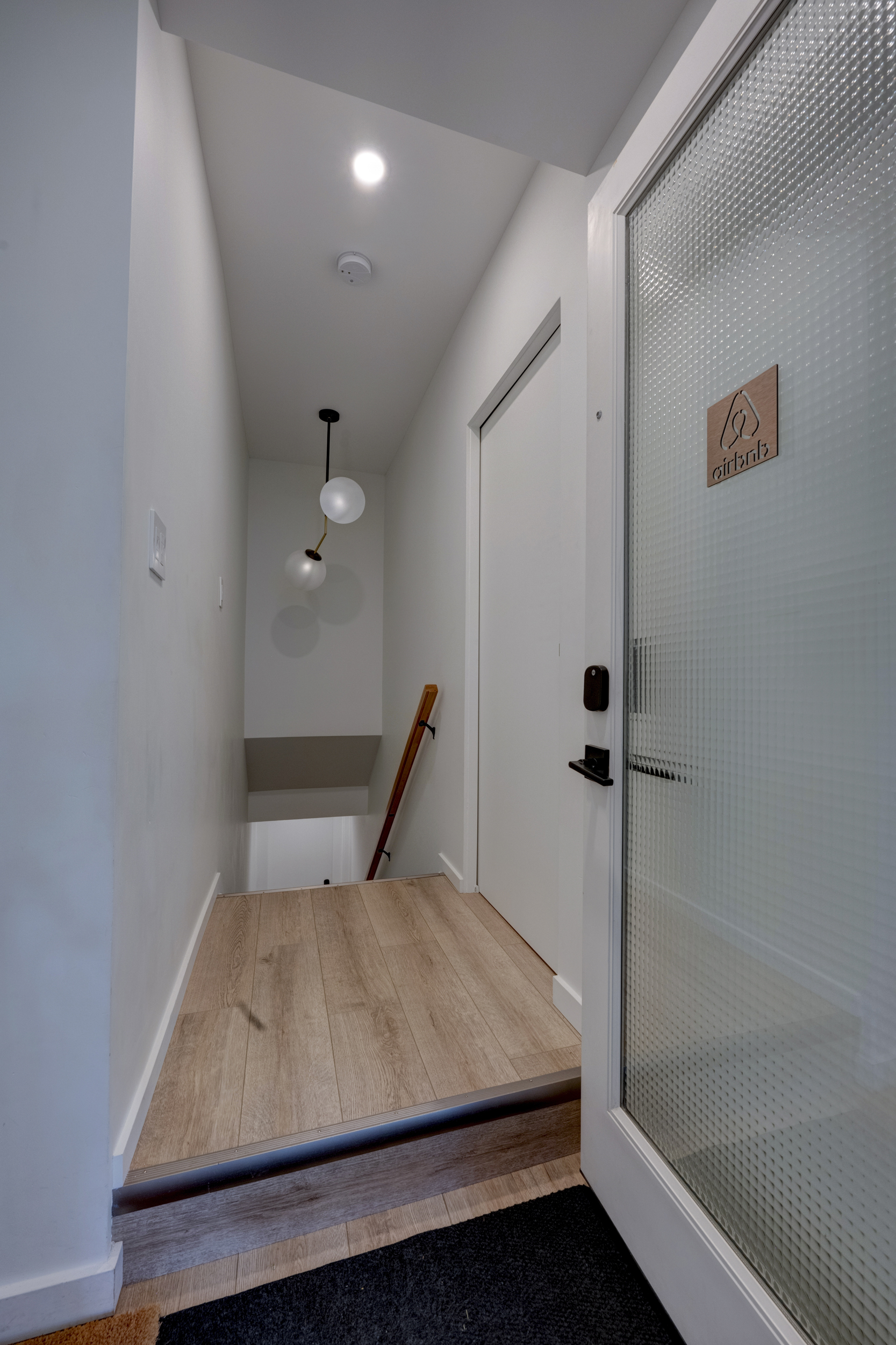 Stairway down to the suite — shoe storage is just inside the door to the left.