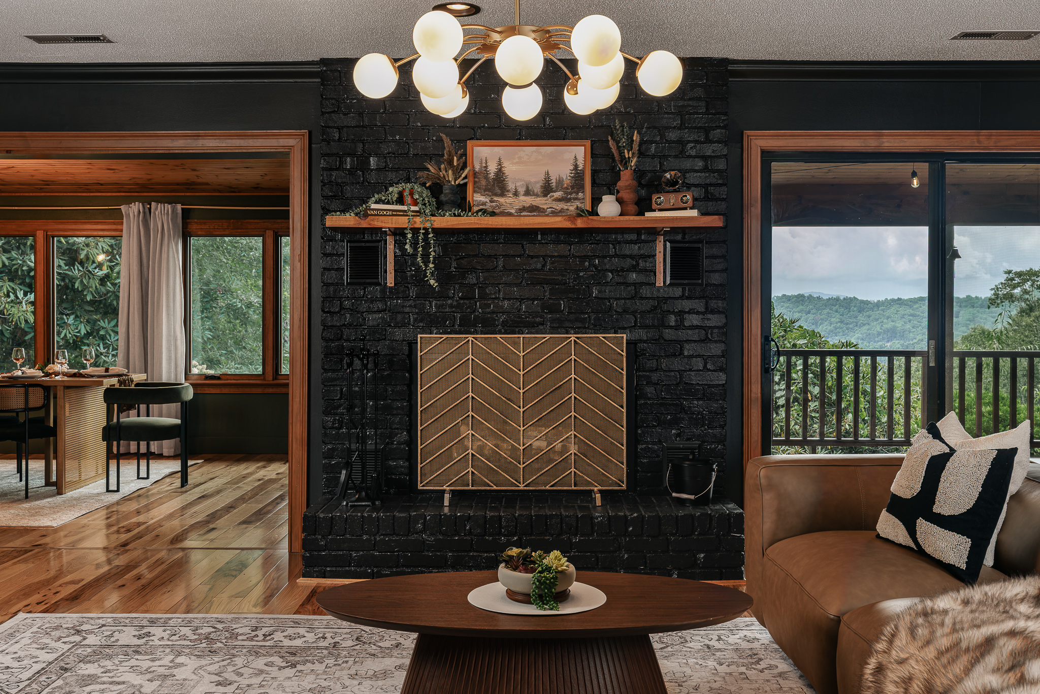 {Living Room} Gather around the statement fireplace with mountain views just beyond the glass and easy flow into the kitchen and dining spaces.