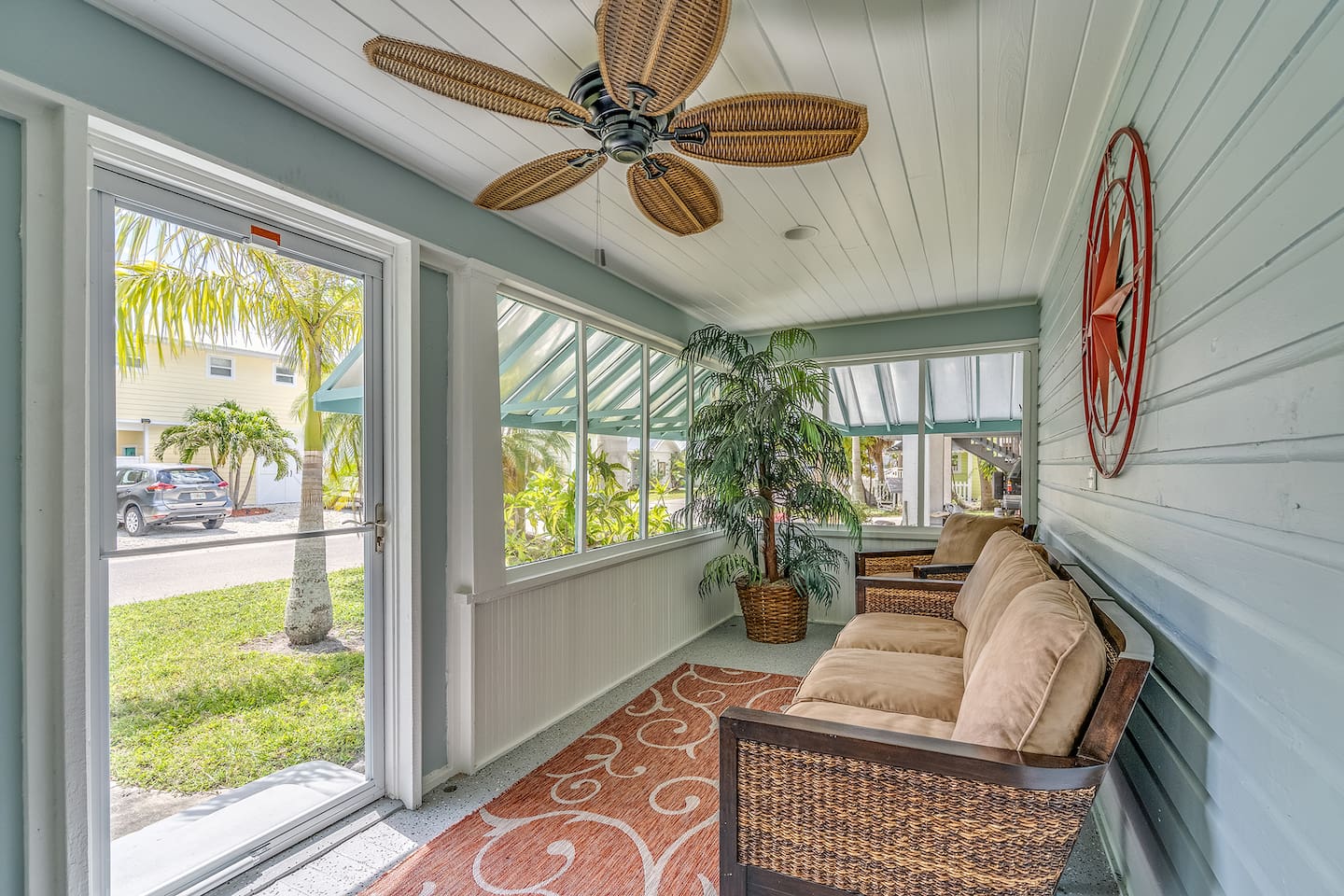 Front screened porch facing the road with front lawn and walkway