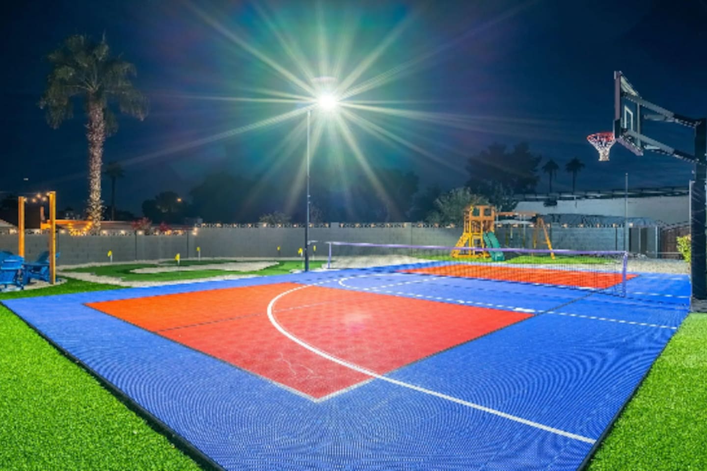 Full-size basketball and pickleball court, lit up and ready whenever the group wants to run it back.